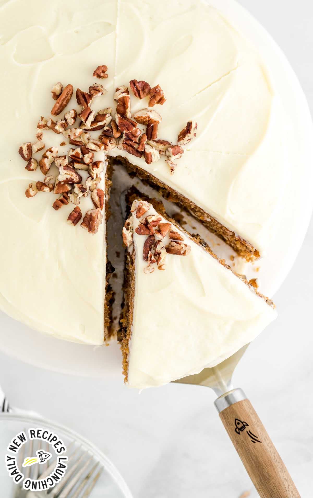 close up overhead shot of a cake with a slice being removed with a spatula