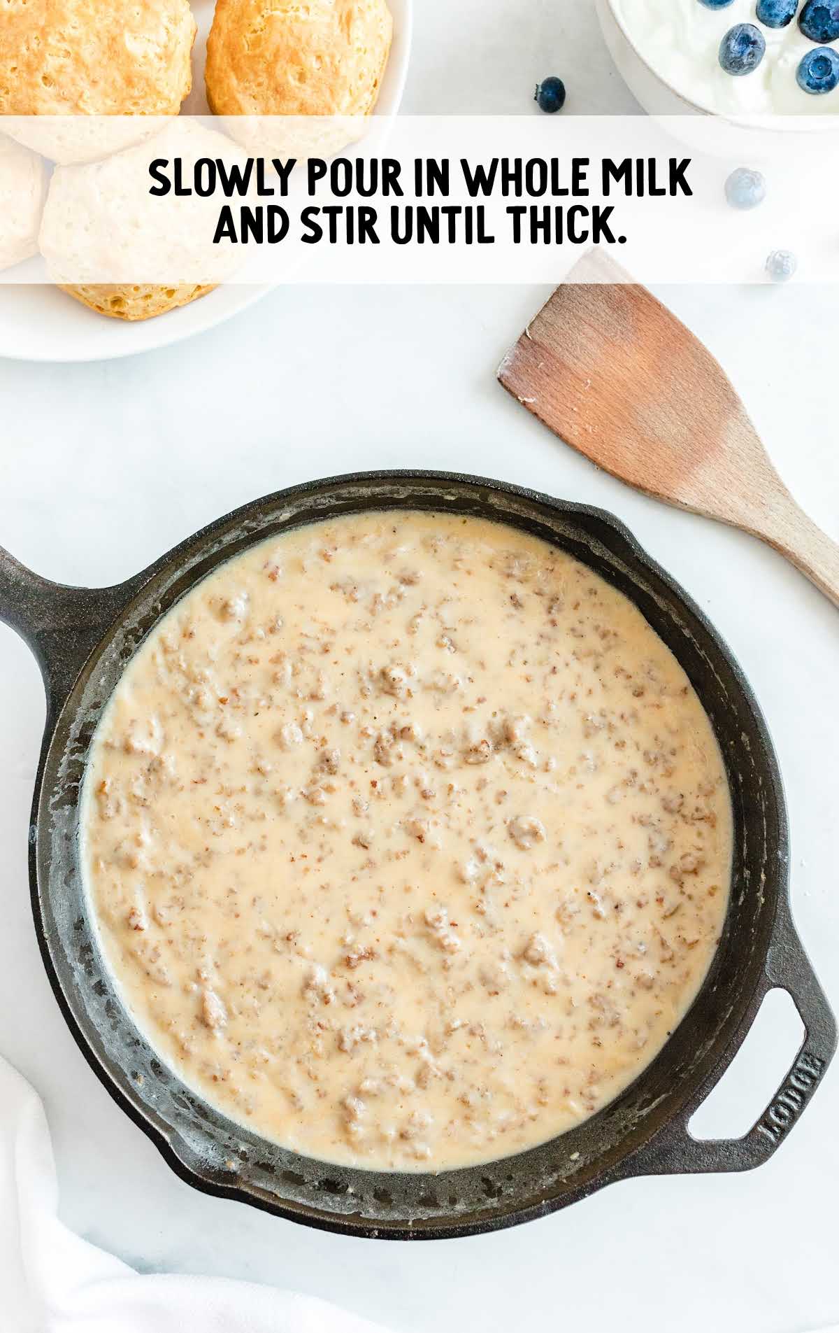 whole milk poured into the meat mixture in the skillet