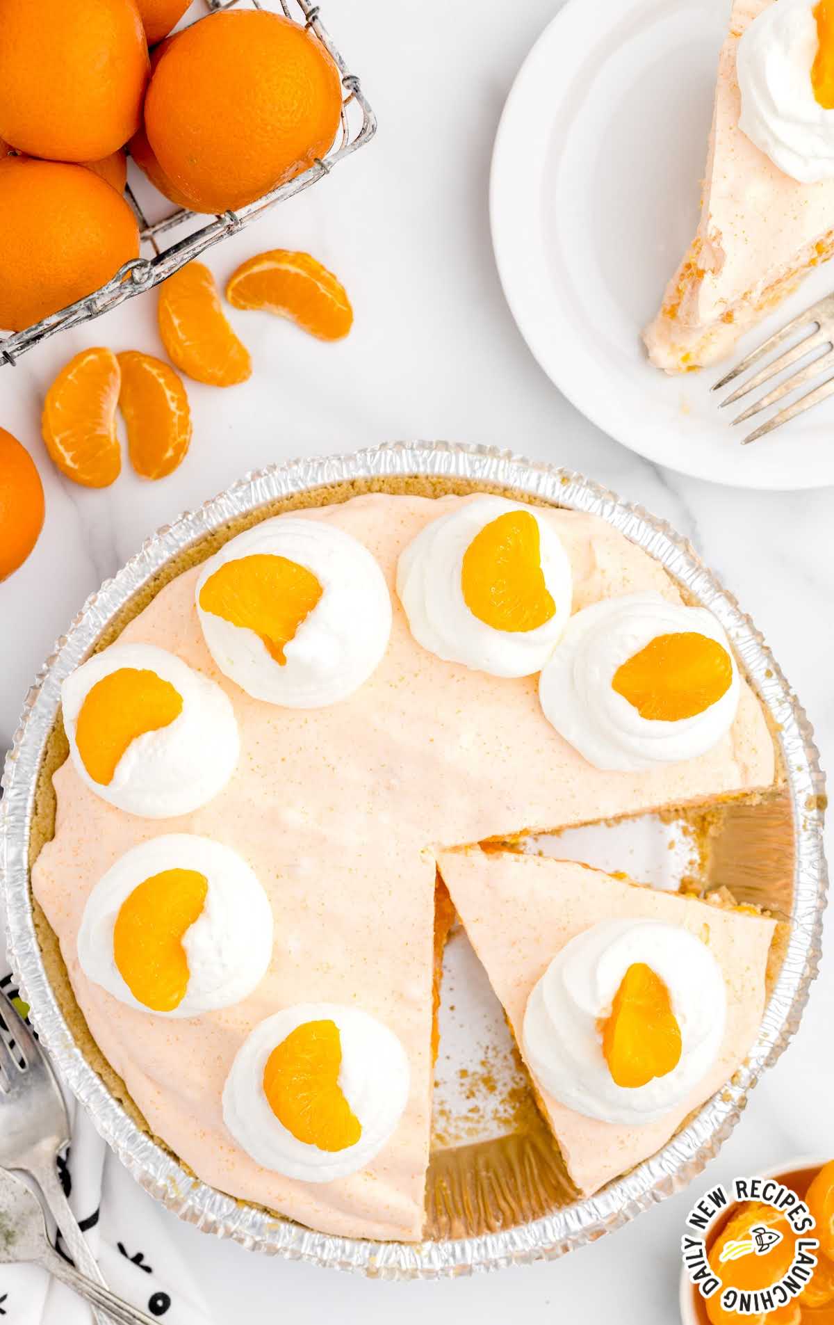 overhead shot of a pie topped with whipped cream and mandarin oranges
