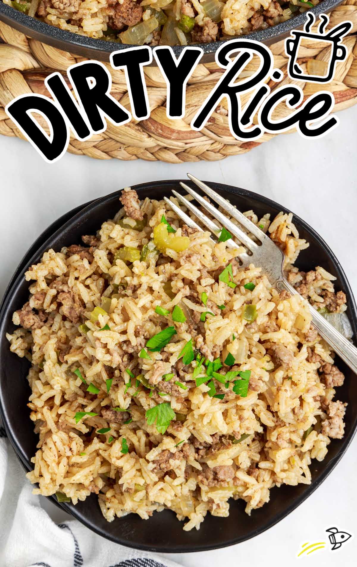 close up overhead shot of a plate of Dirty Rice with a fork