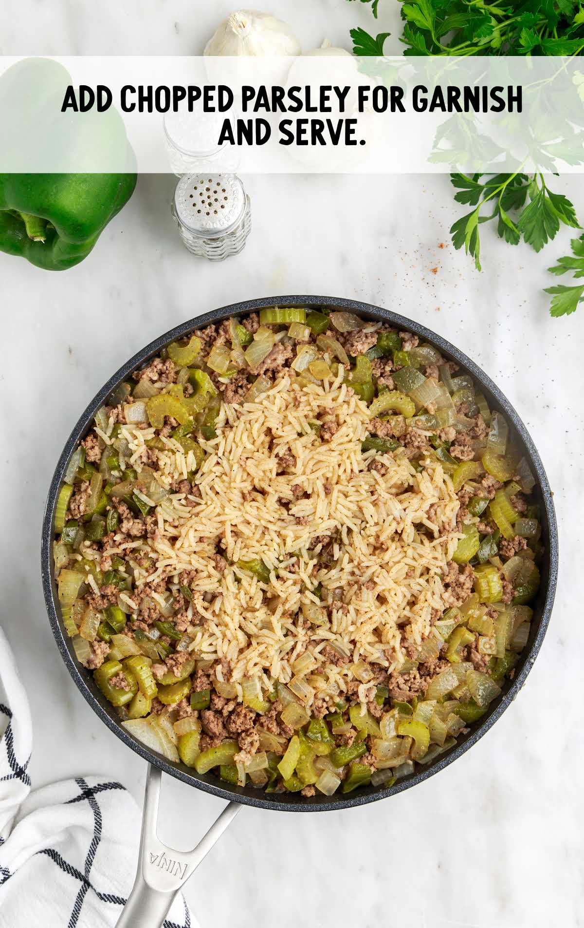 rice topped with parsley in a skillet