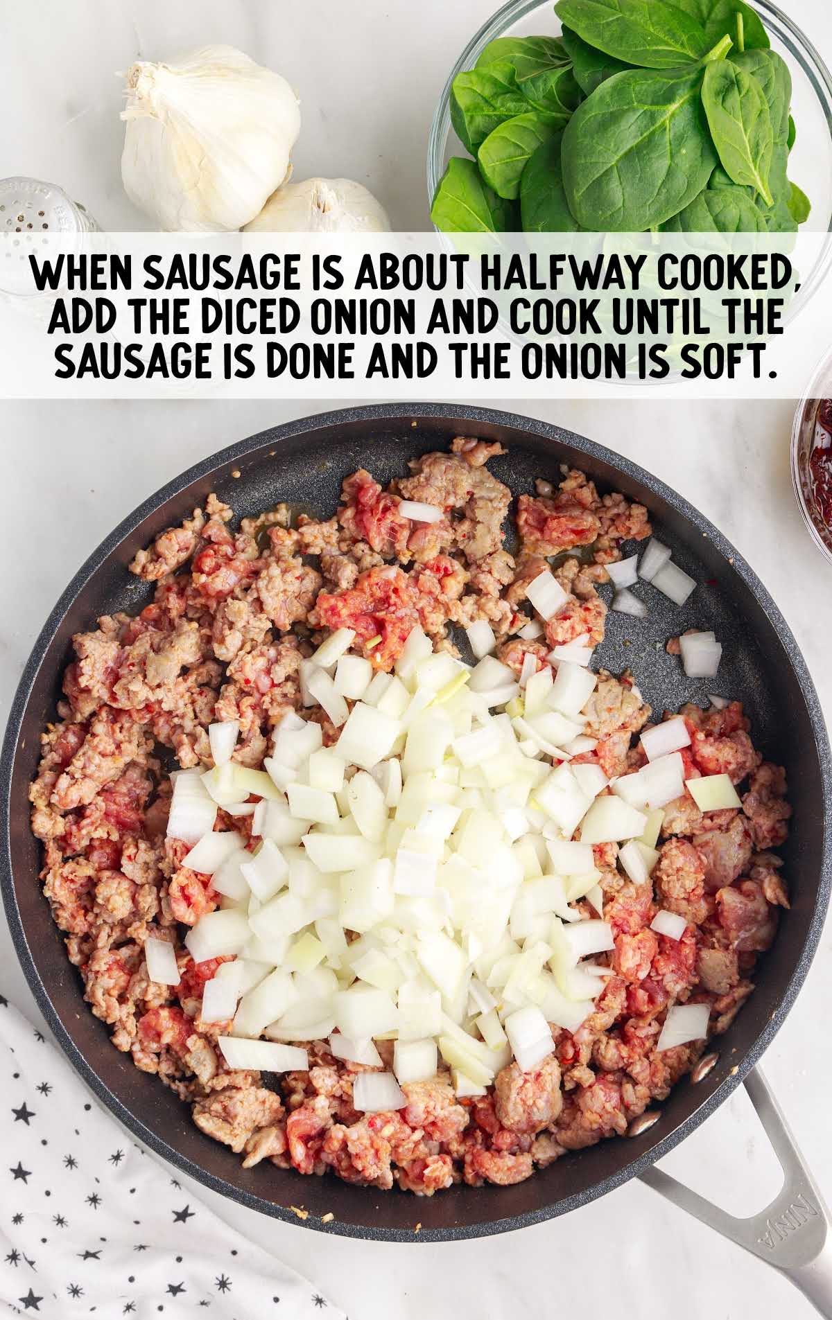 sausage and diced onion being cooked in a skillet