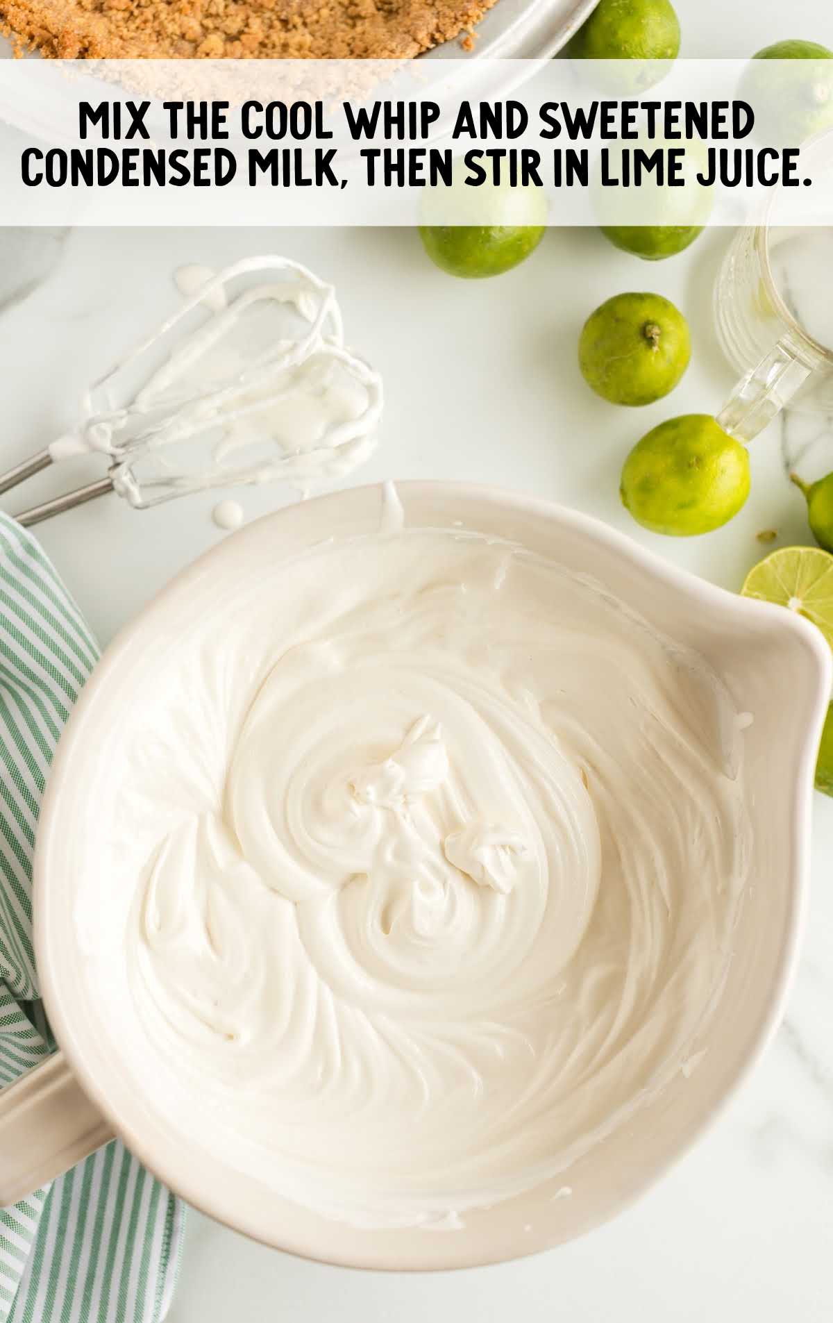 cool whip and condensed milk whisked together in a bowl