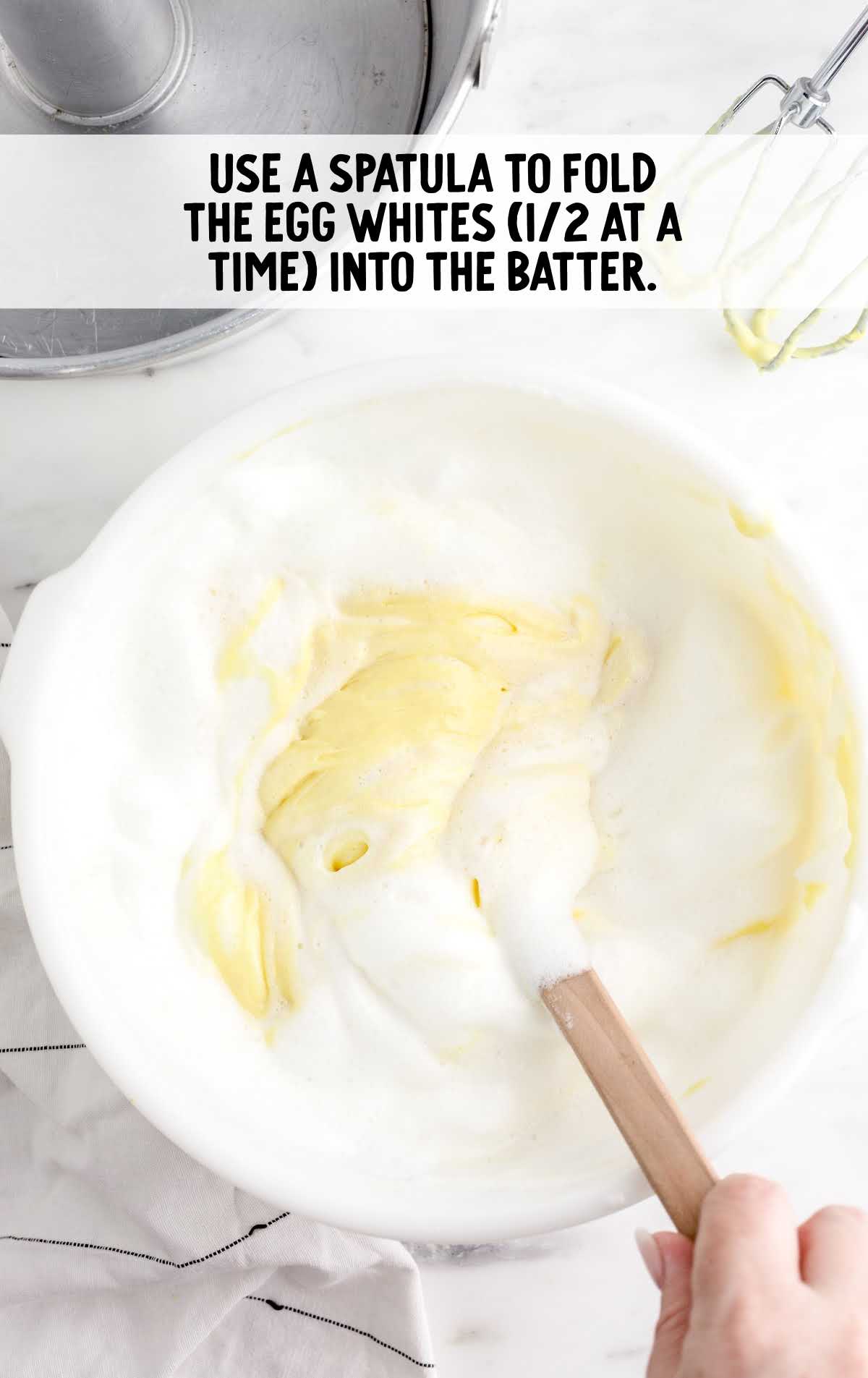 egg whites being folded into the cake batter