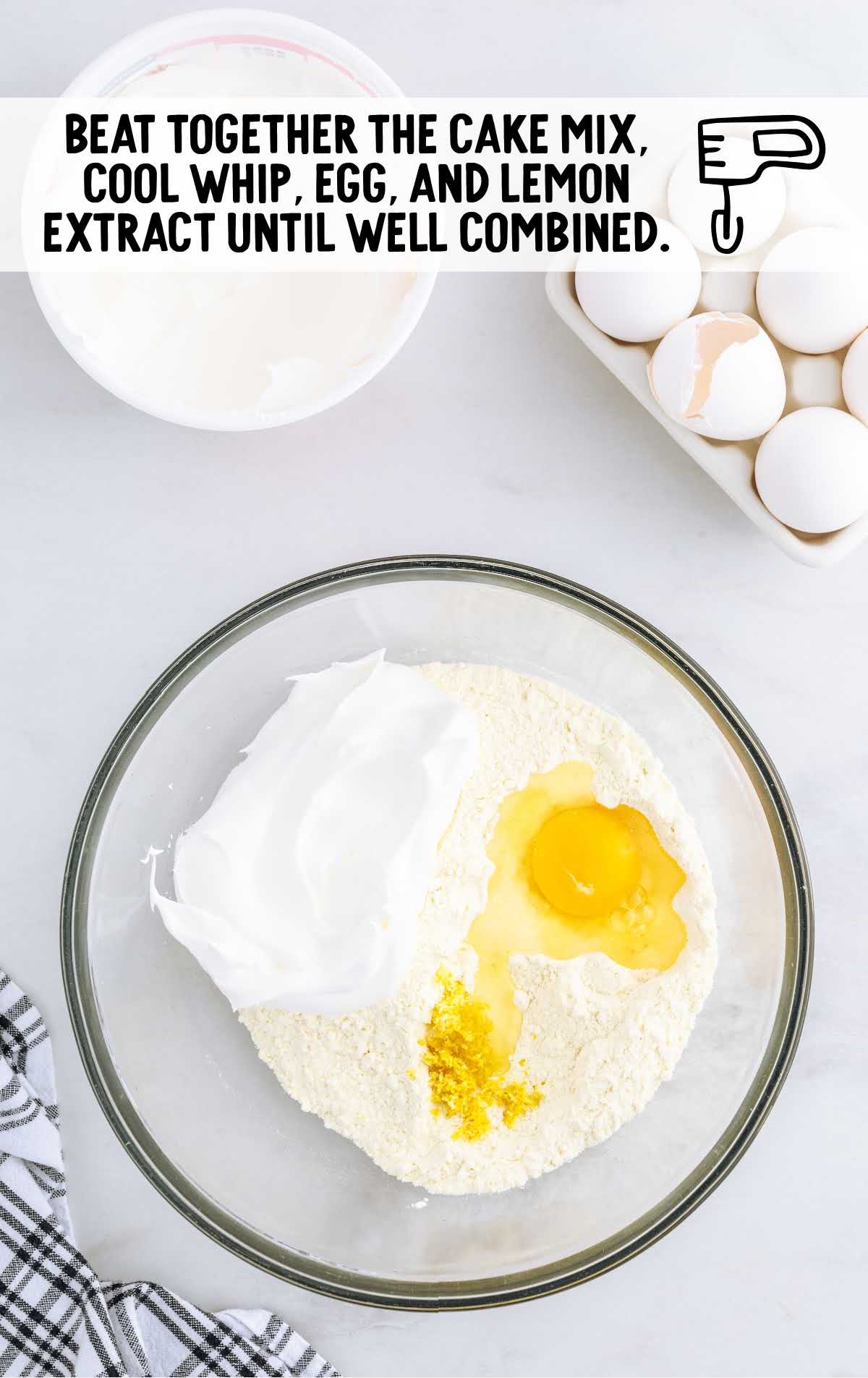 cake mix, Cool Whip, egg, and lemon zest combined in a bowl