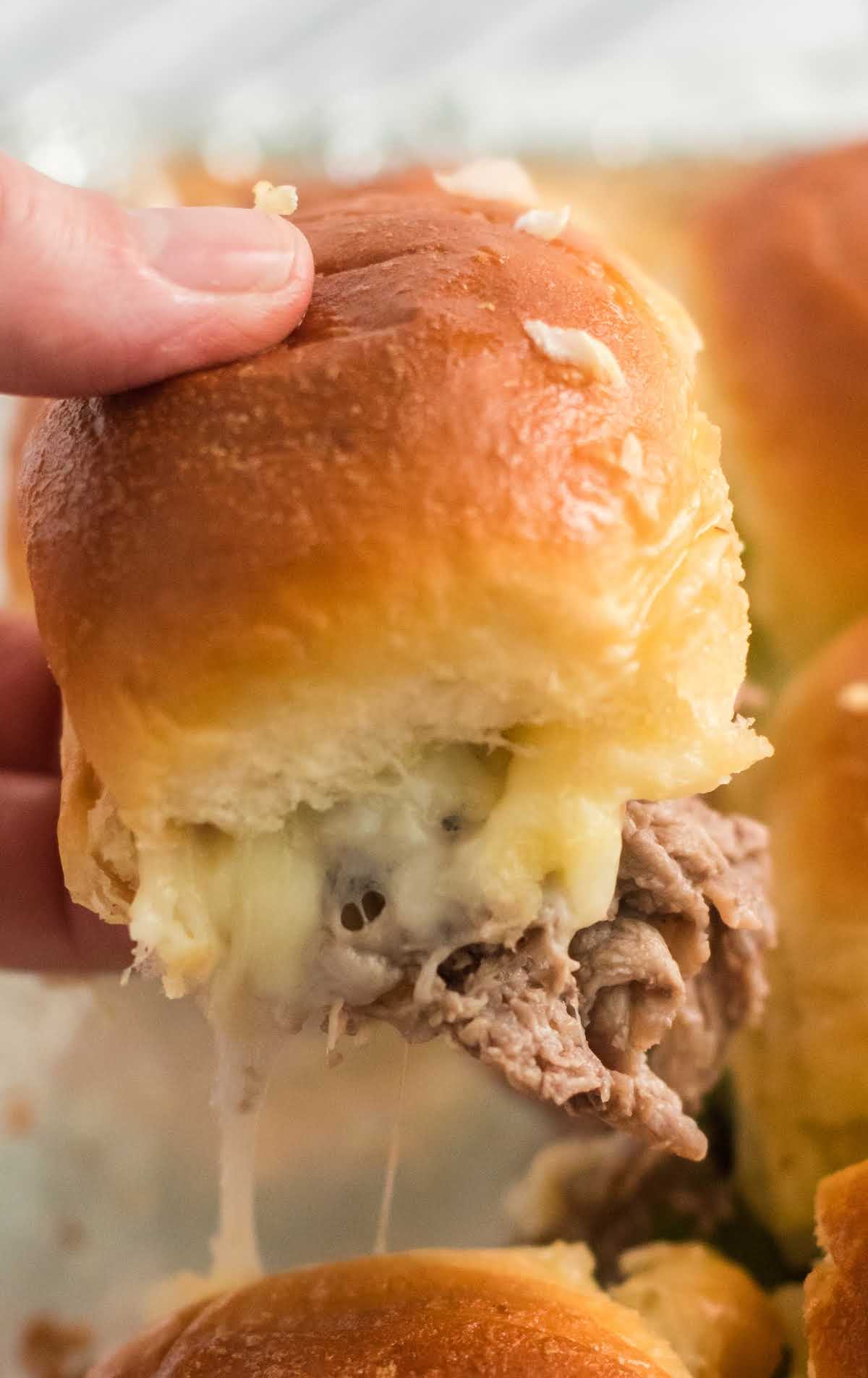 close up shot of Philly Cheesesteak Sliders being peeled apart