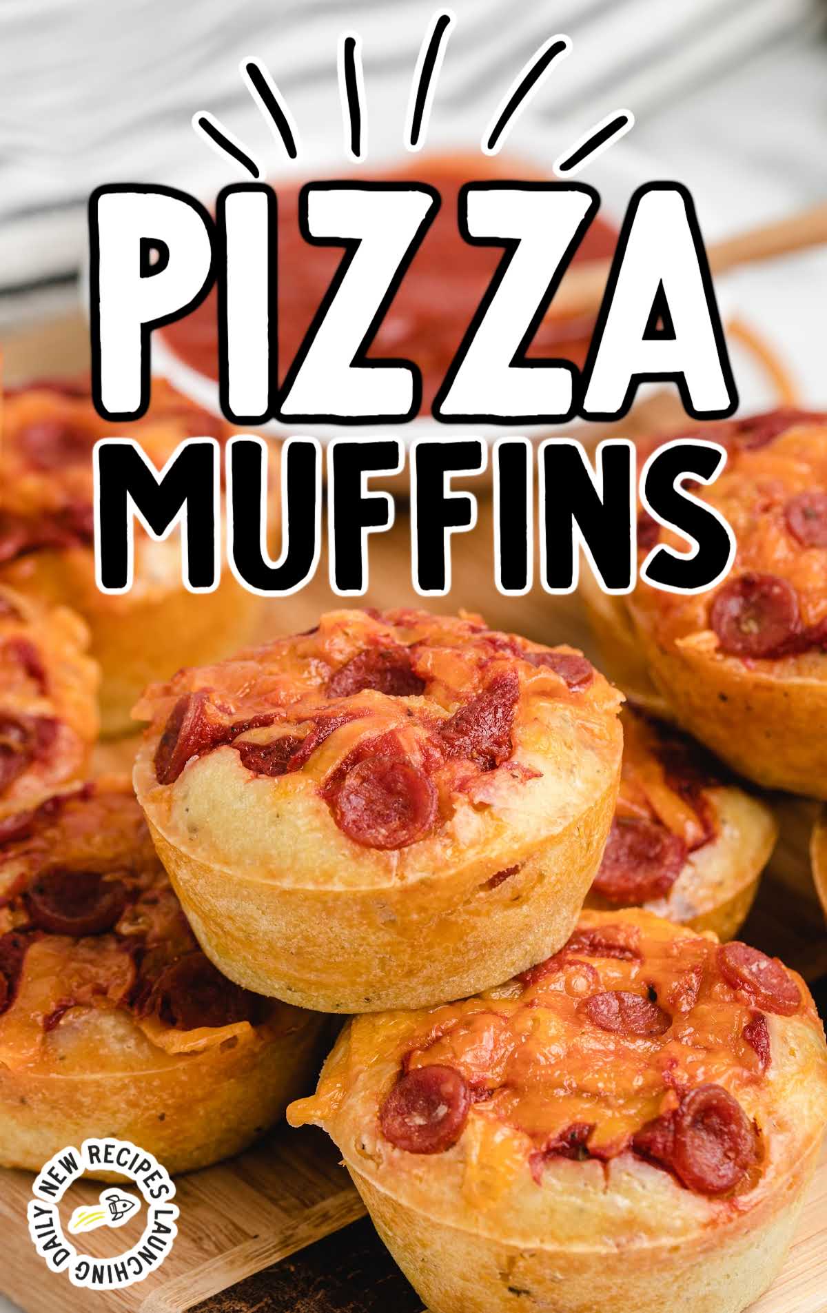 close up shot of Pizza Muffins piled on a wooden board