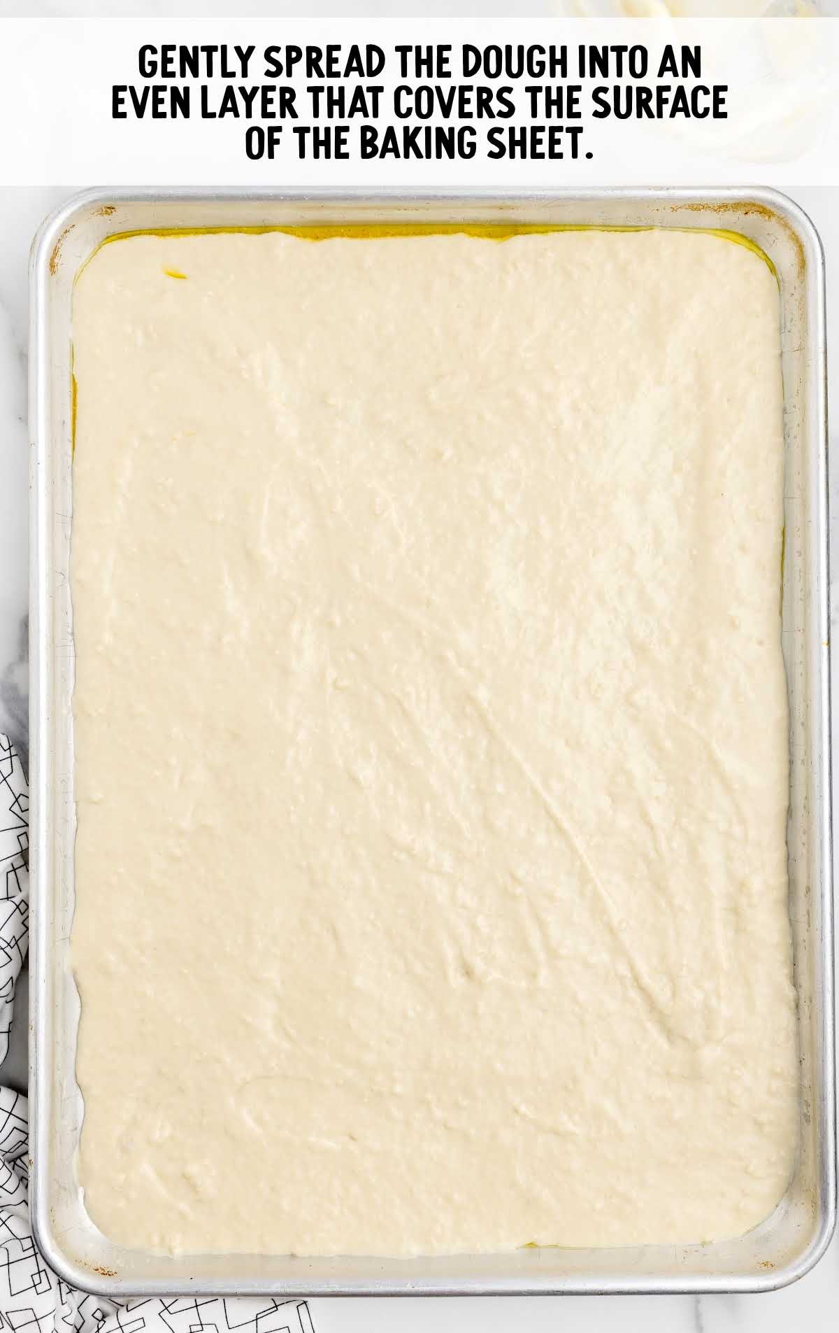 dough spread on top of a baking sheet
