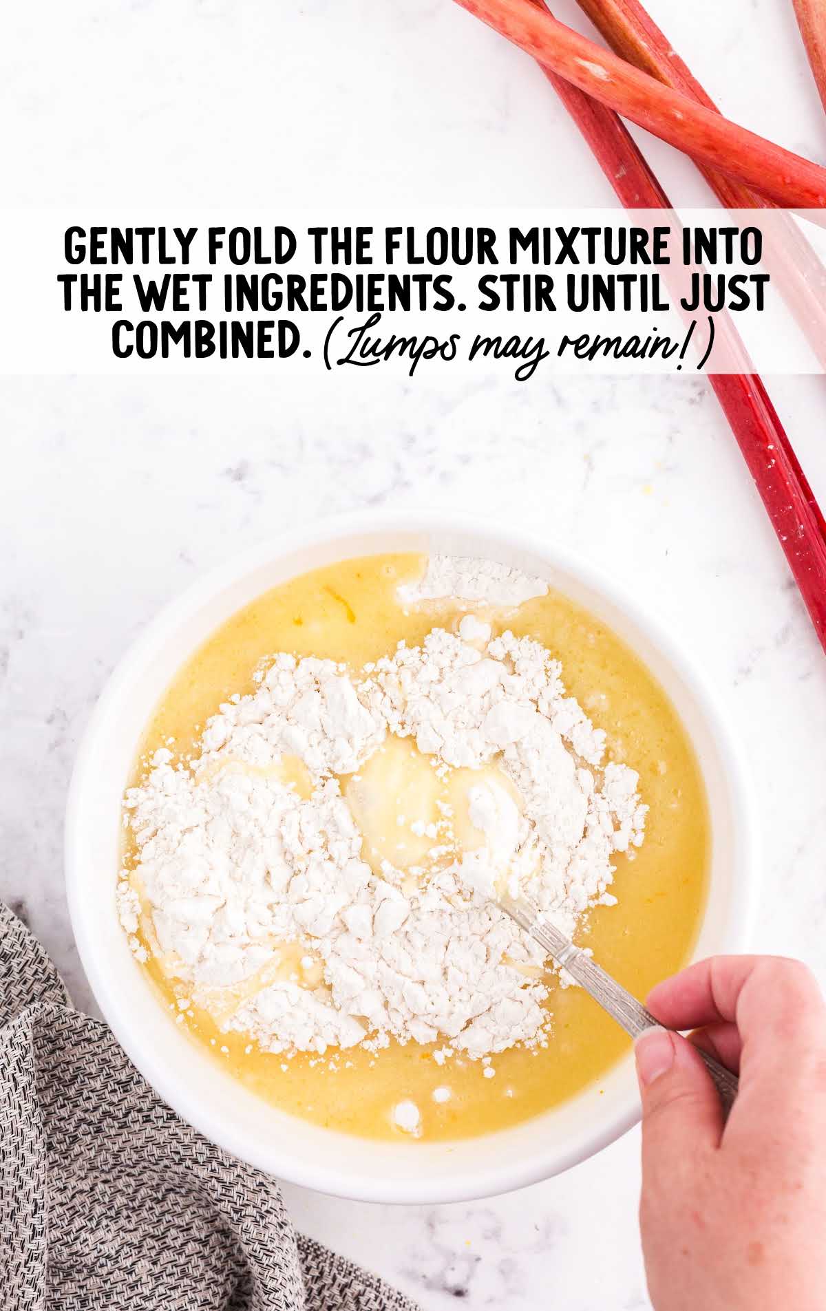 flour mixture folded into the wet ingredients in a bowl