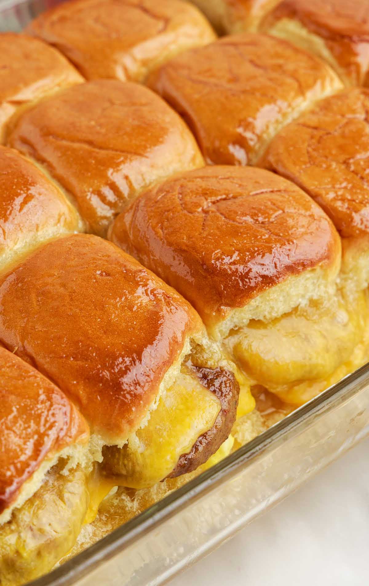 close up shot of a bunch of Sausage Egg and Cheese Sliders in a baking dish