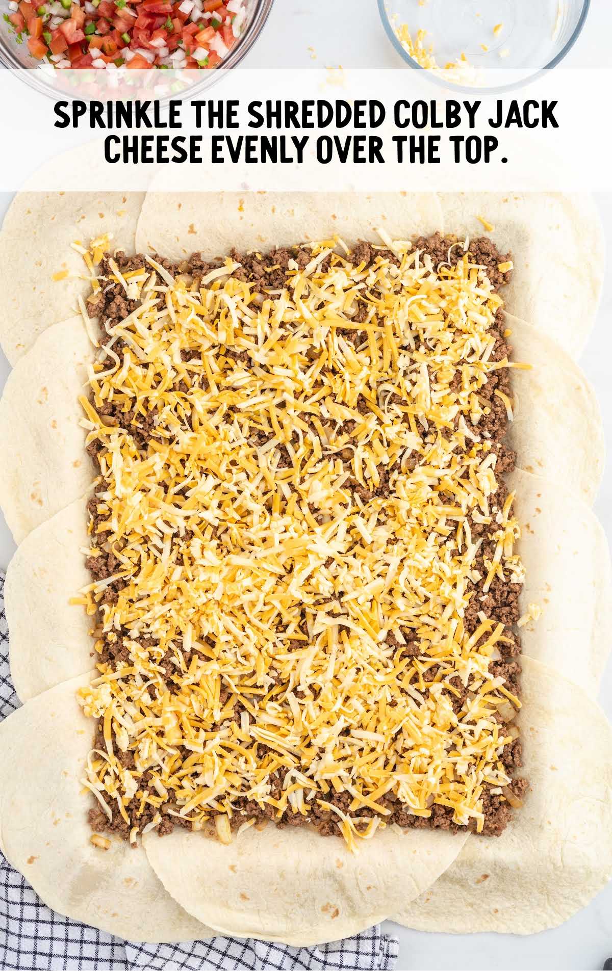 Colby jack cheese sprinkled on top of the ground beef mixture