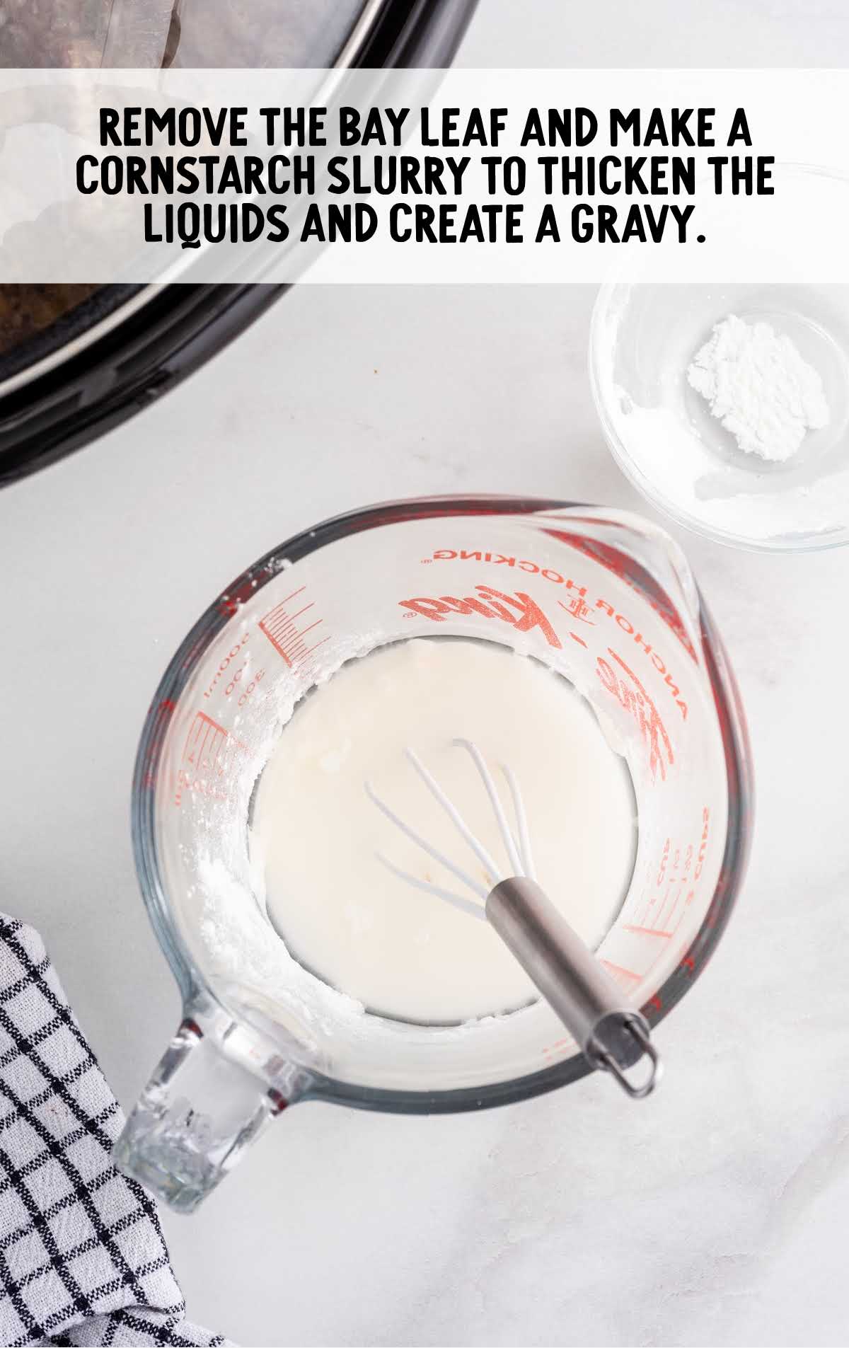 cornstarch slurry being made in a measuring cup