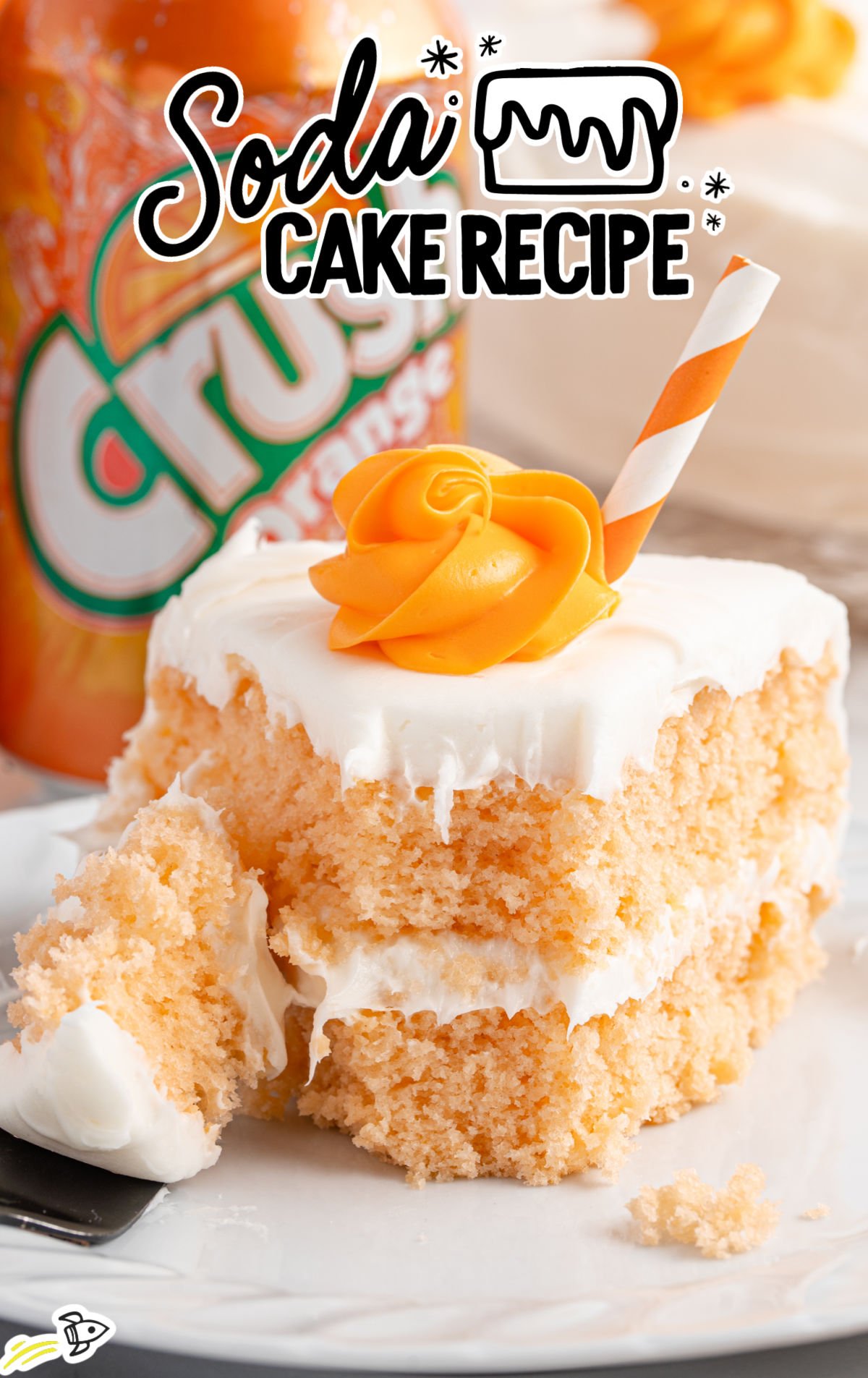 Close-up of a slice of orange soda cake with a fluffy white frosting layer and an orange rosette on top, decorated with an orange-and-white striped straw. The soft, tender crumb is visible where a forkful has been taken.