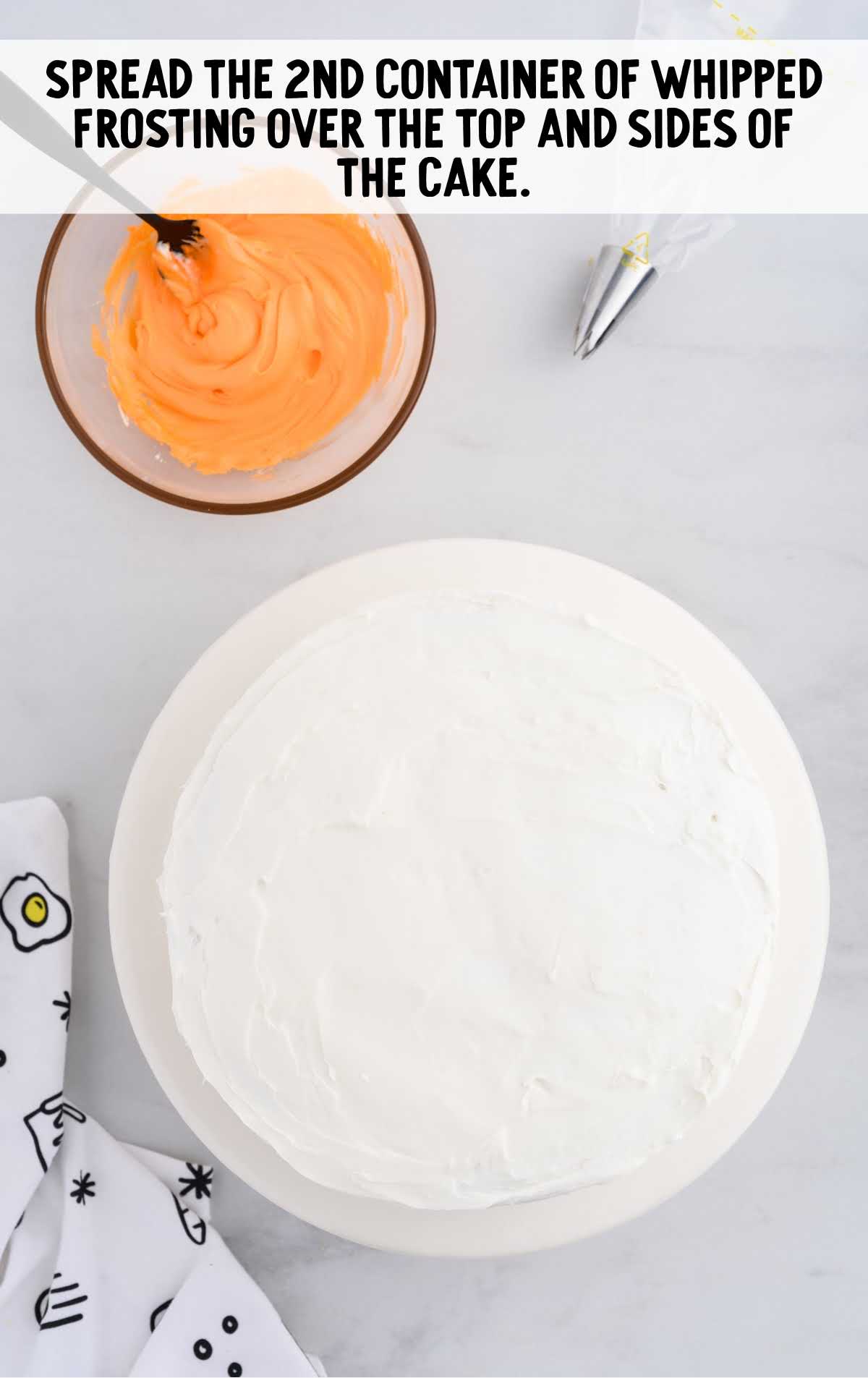 frosting spread on top of the cake