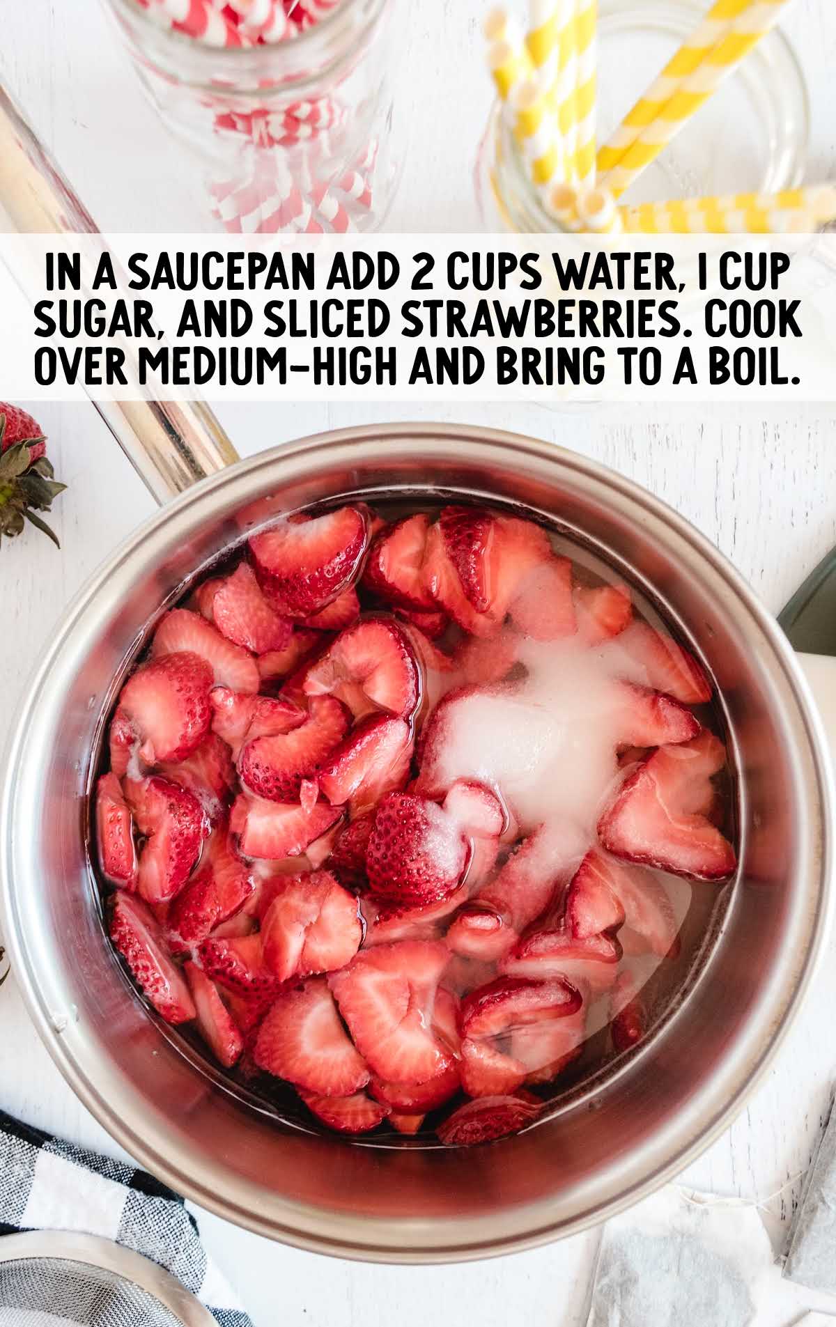 water, sugar, and strawberries added to a pot