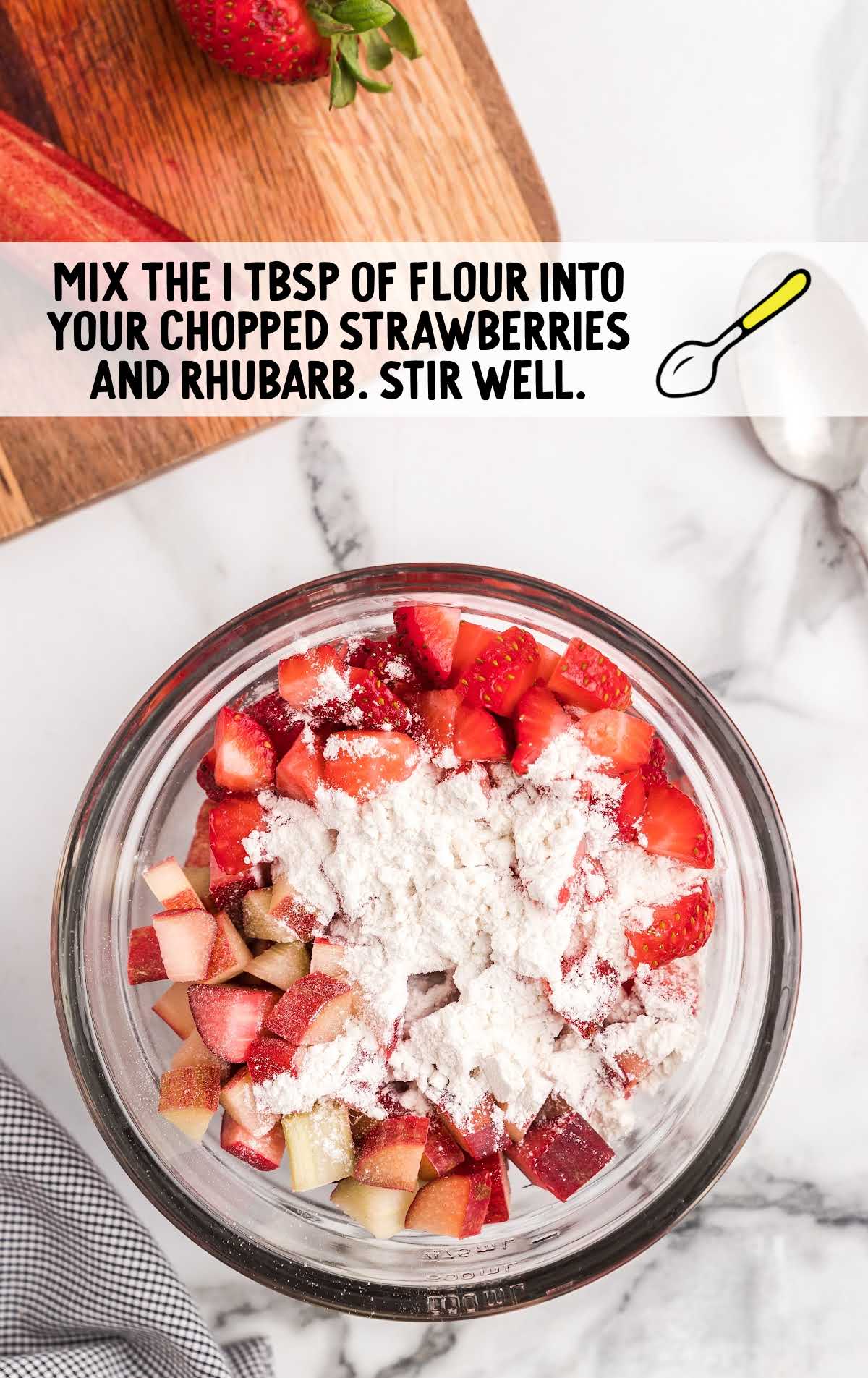 chopped strawberries and rhubarb mixed together with flour in a bowl