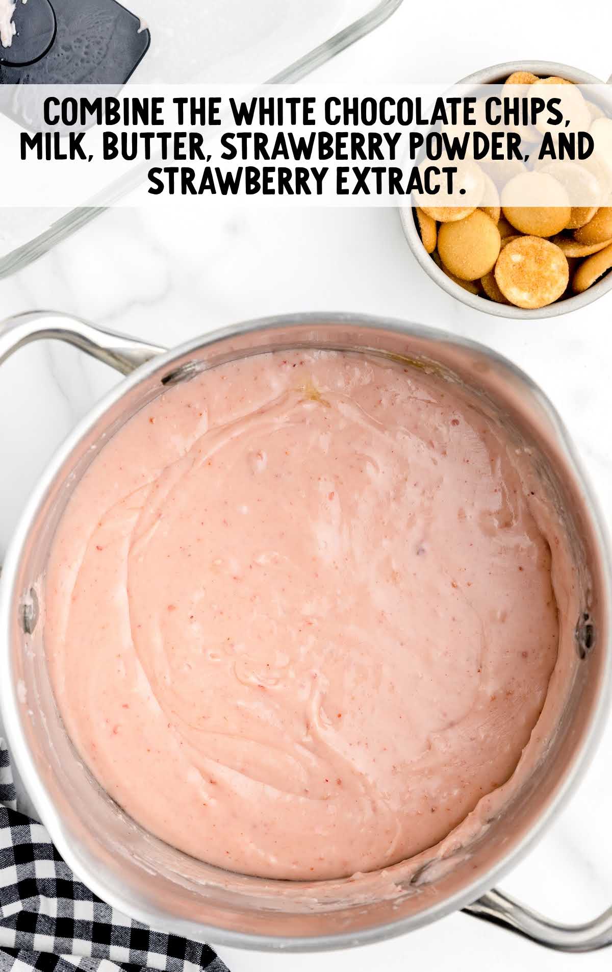 white chocolate chips, sweetened condensed milk, remaining two tablespoons of unsalted butter, freeze-dried strawberry powder, and strawberry extract added to a pot