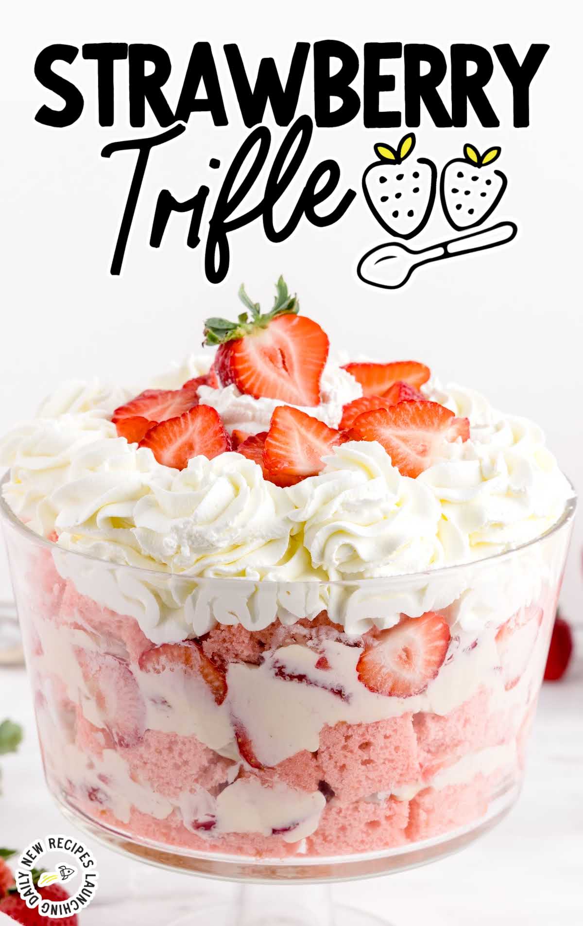 close up shot of a big serving bowl of trifle topped with chopped strawberries