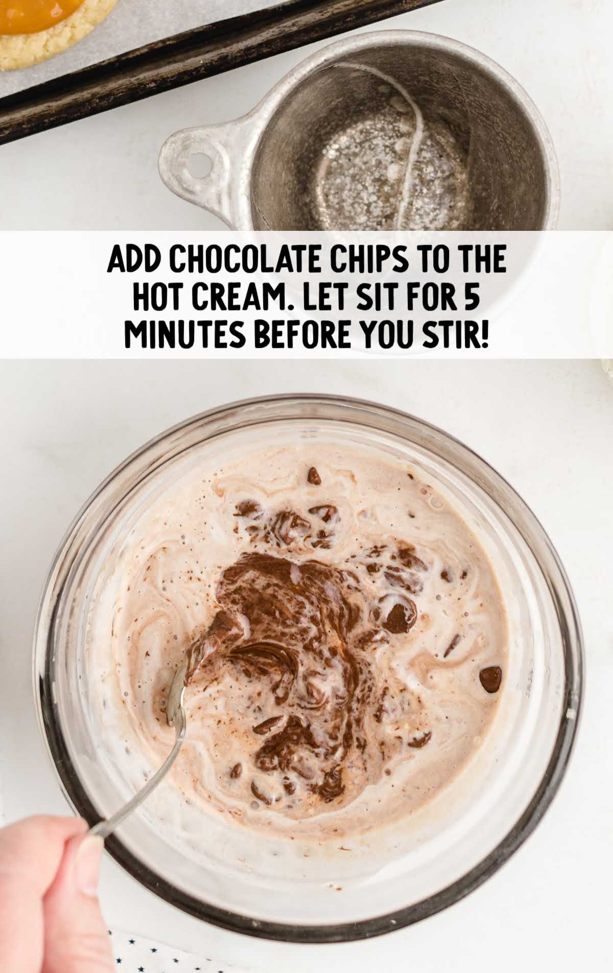 chocolate chips and hot cream combined in a bowl