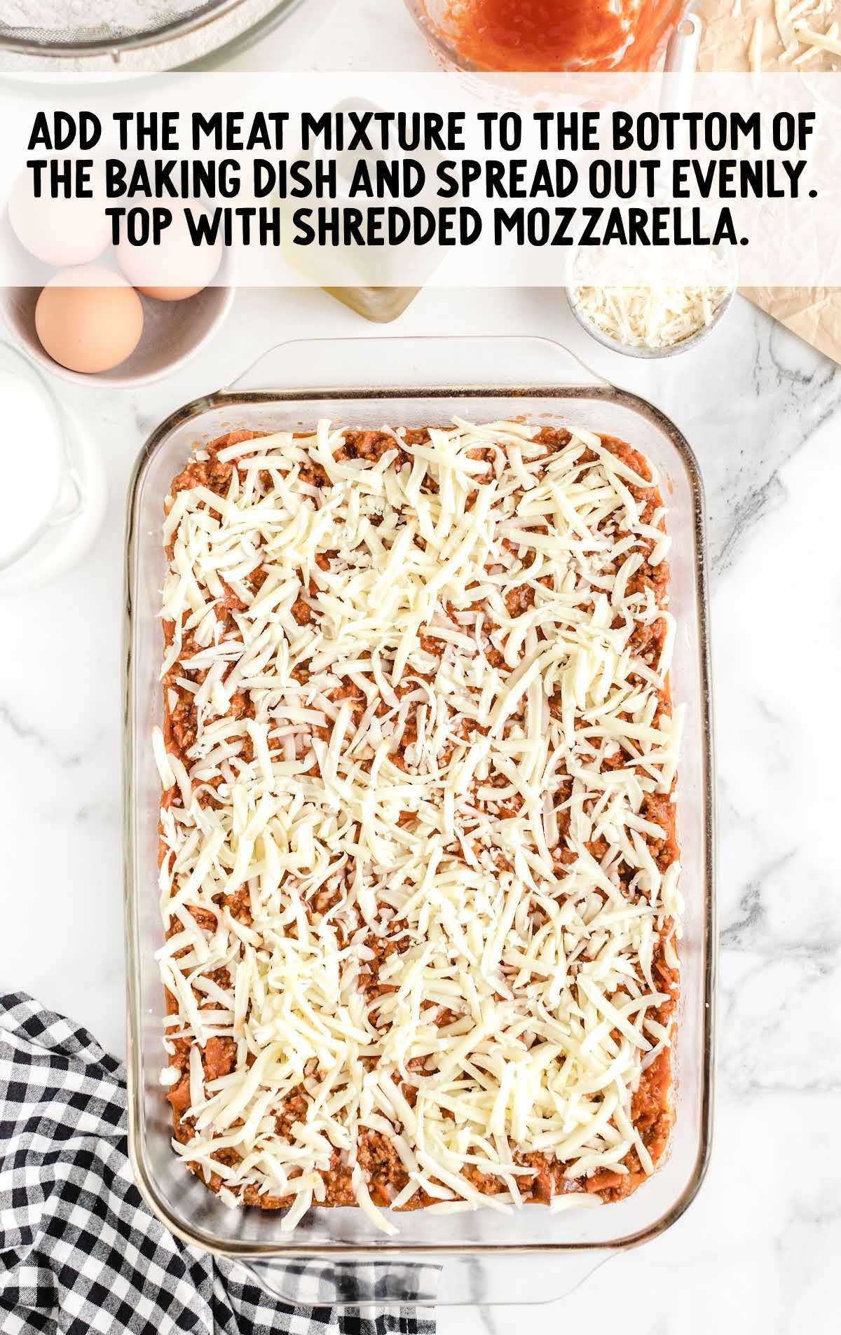 meat mixture placed in a baking dish and topped with mozzarella cheese