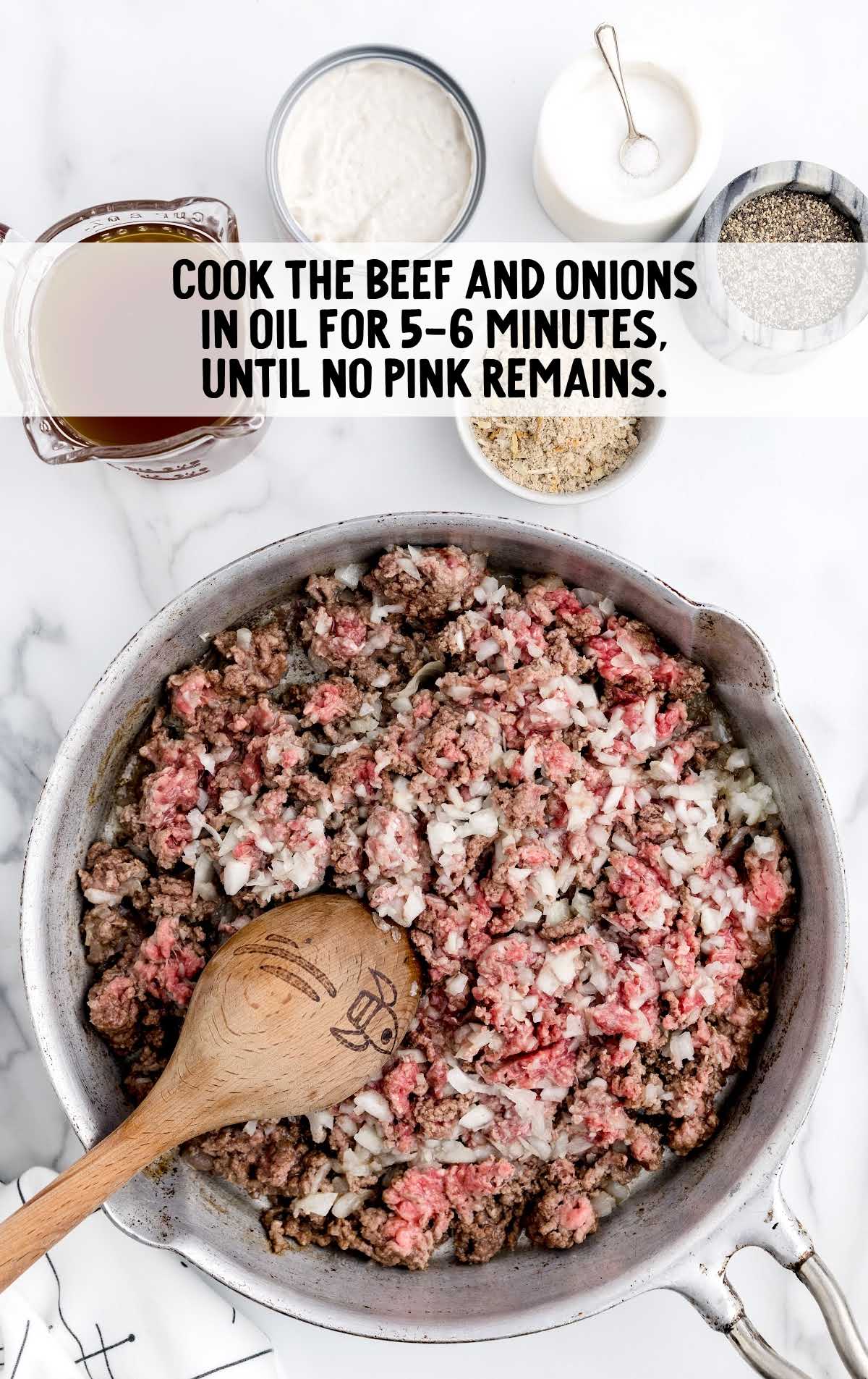ground beef and onions cooked in a skillet