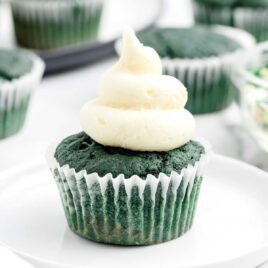 a close up shot of a green cupcake on a plate