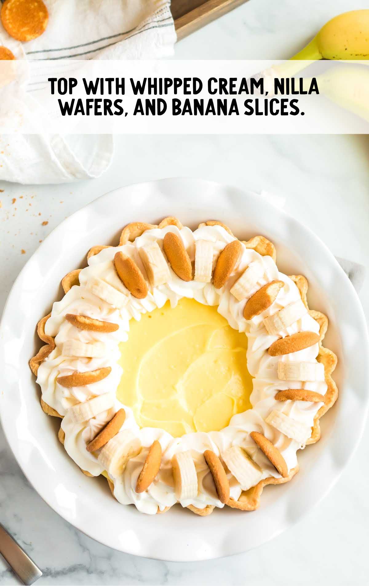 pie topped with whipped cream and vanilla wafers