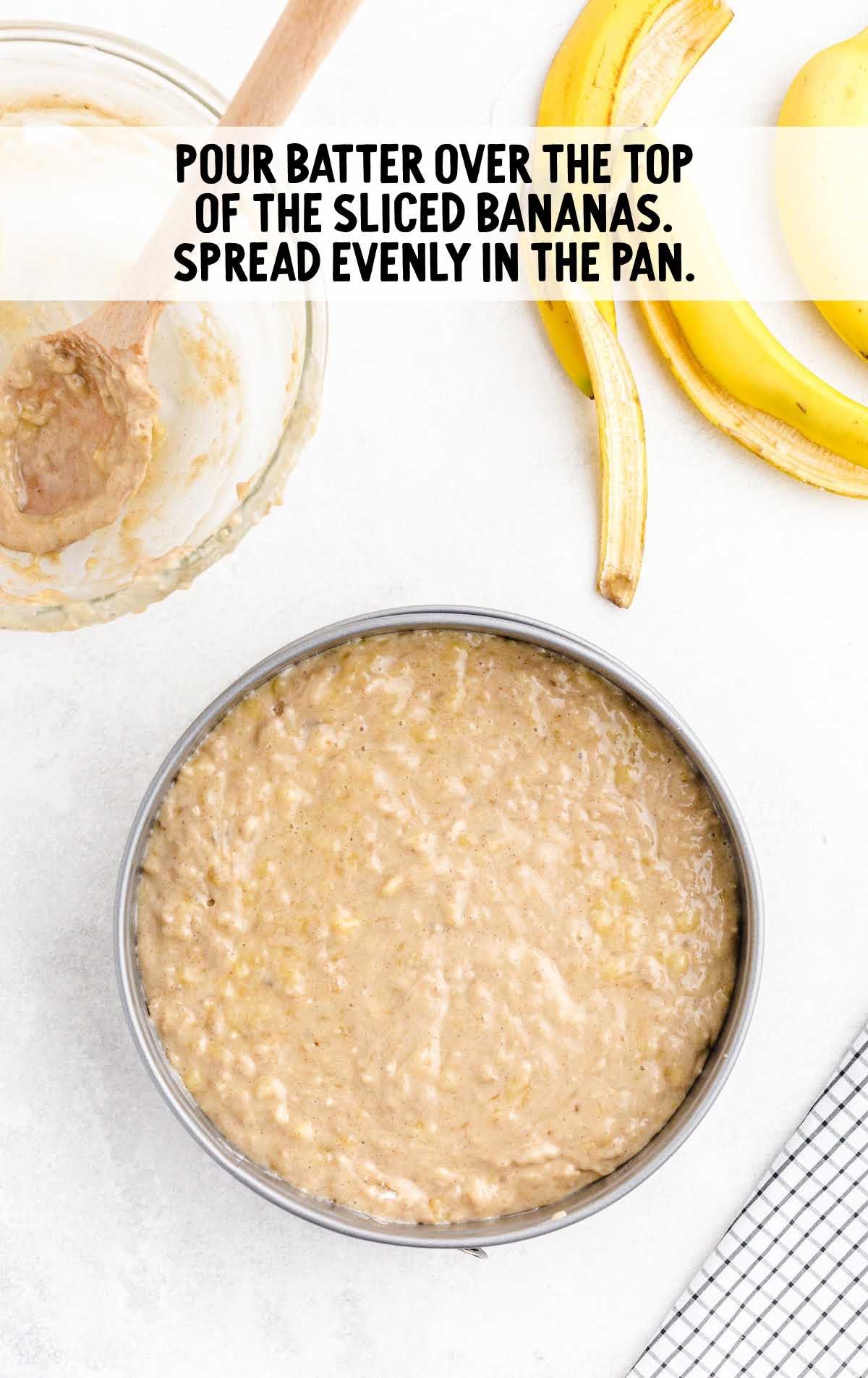 batter placed on top of the banana slices in a cake pan