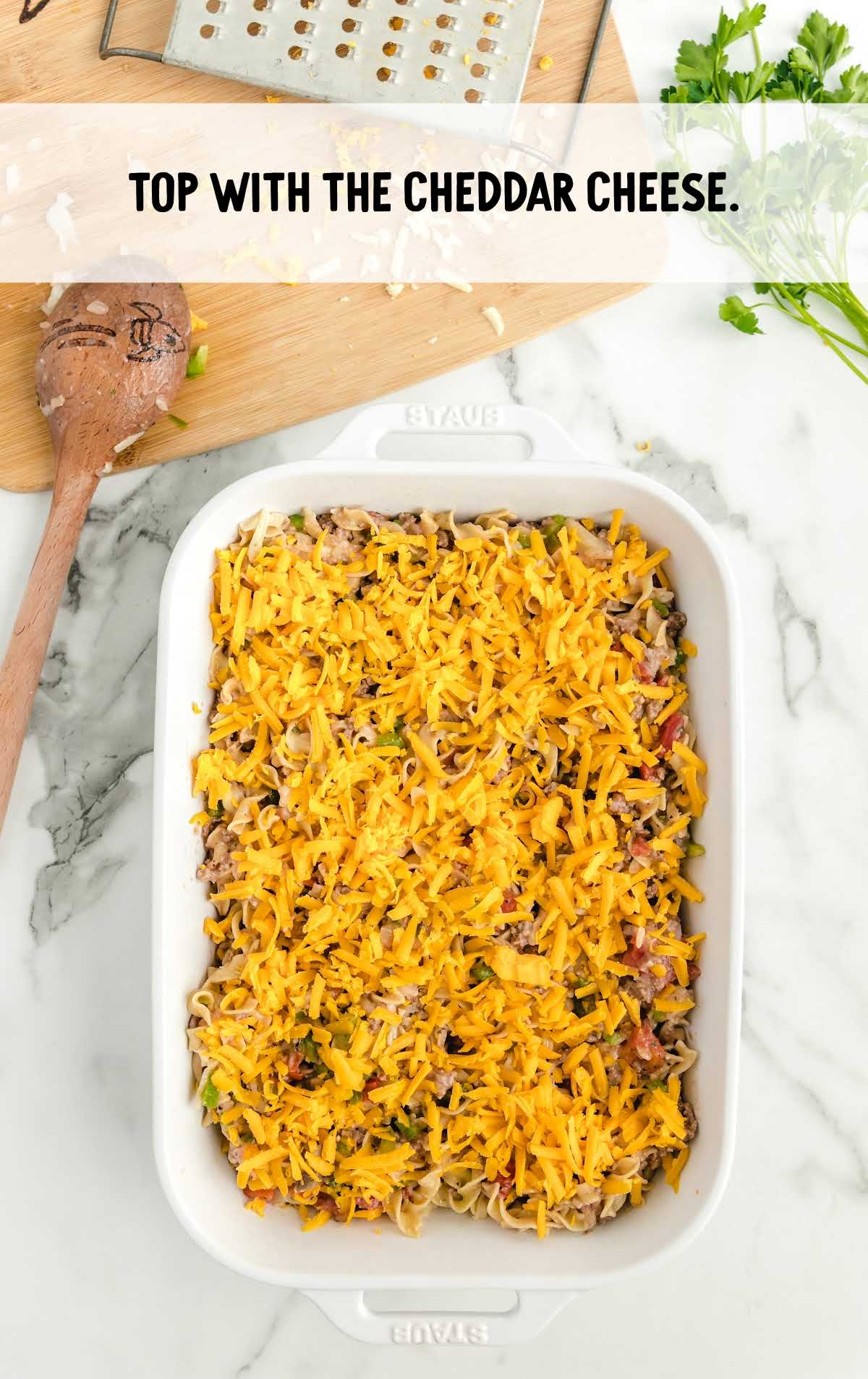 casserole topped with cheddar cheese in a baking dish