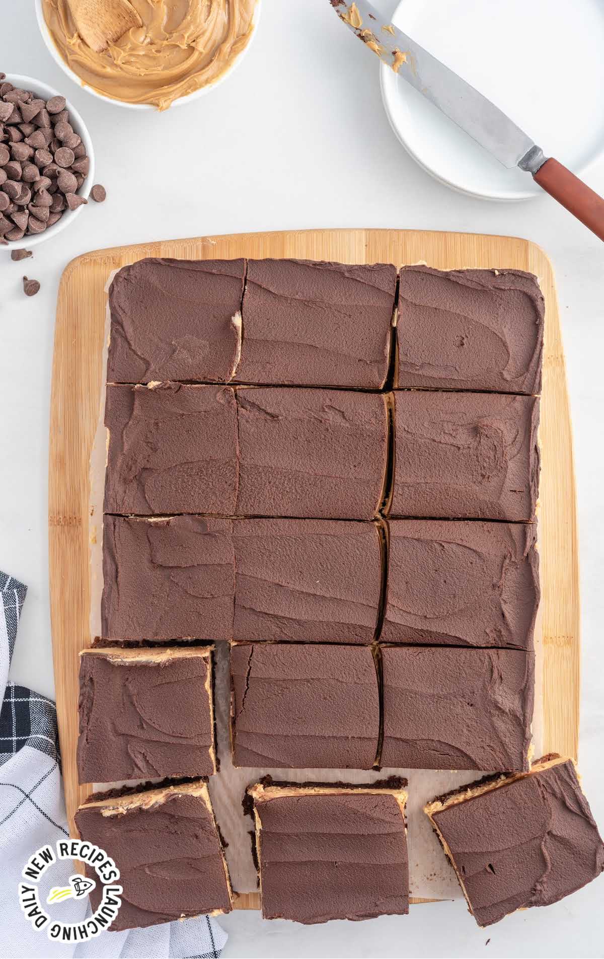 overhead shot of chocolate and peanut butter brownies on a wooden board