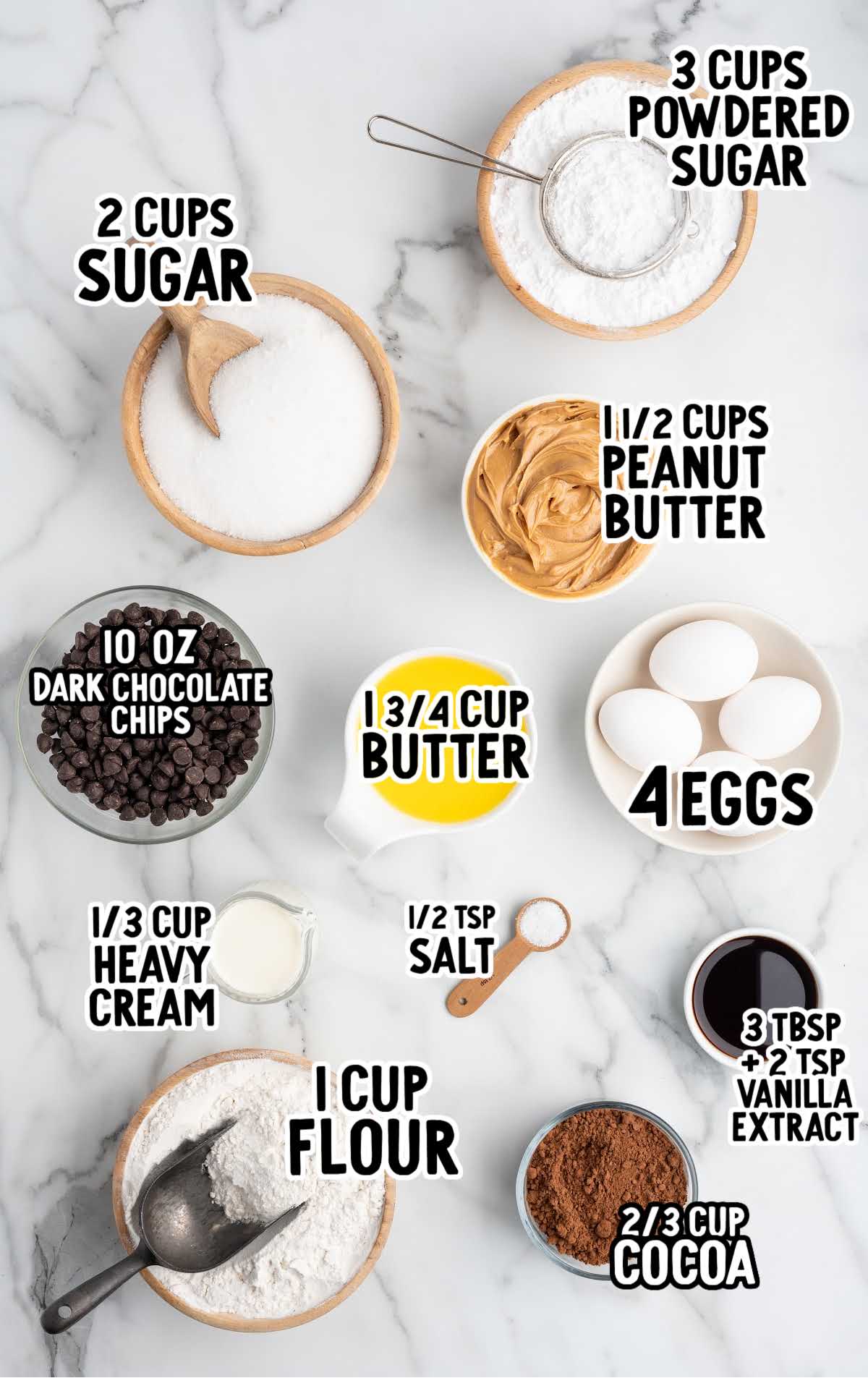 Overhead shot of measured ingredients for buckeye brownies including sugar, peanut butter, cocoa, flour, butter, eggs, and chocolate chips.