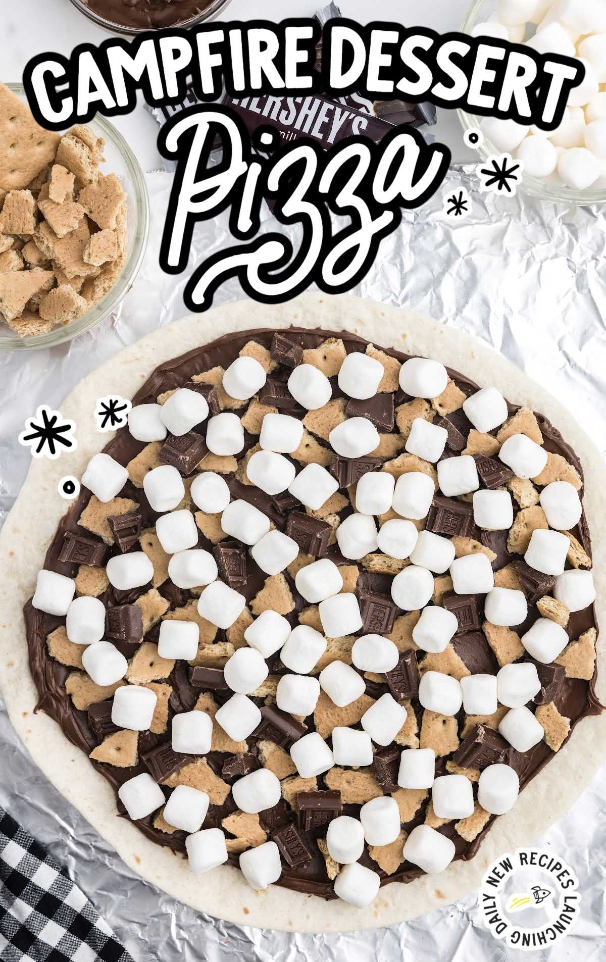 close up shot of a chocolate dessert pizza on top of aluminum foil