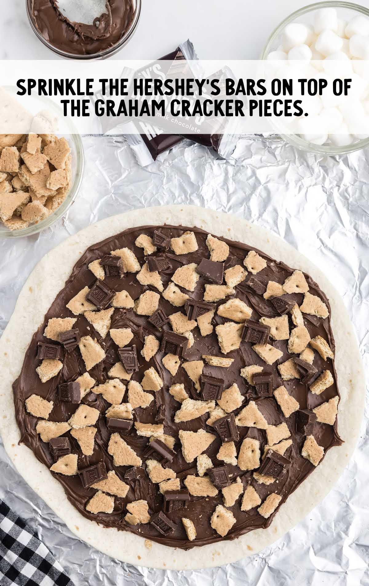 pieces of a Hershey's bar spread on top of the graham crackers