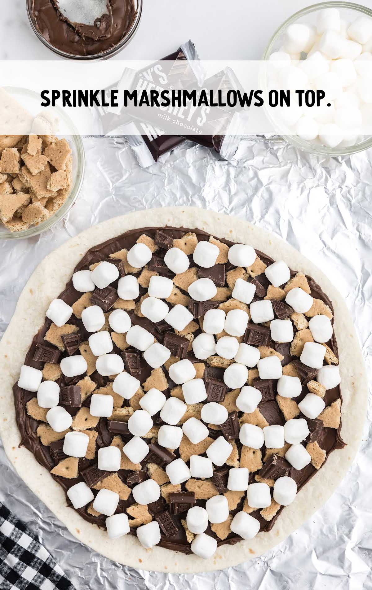 marshmallows spread on top of the dessert pizza