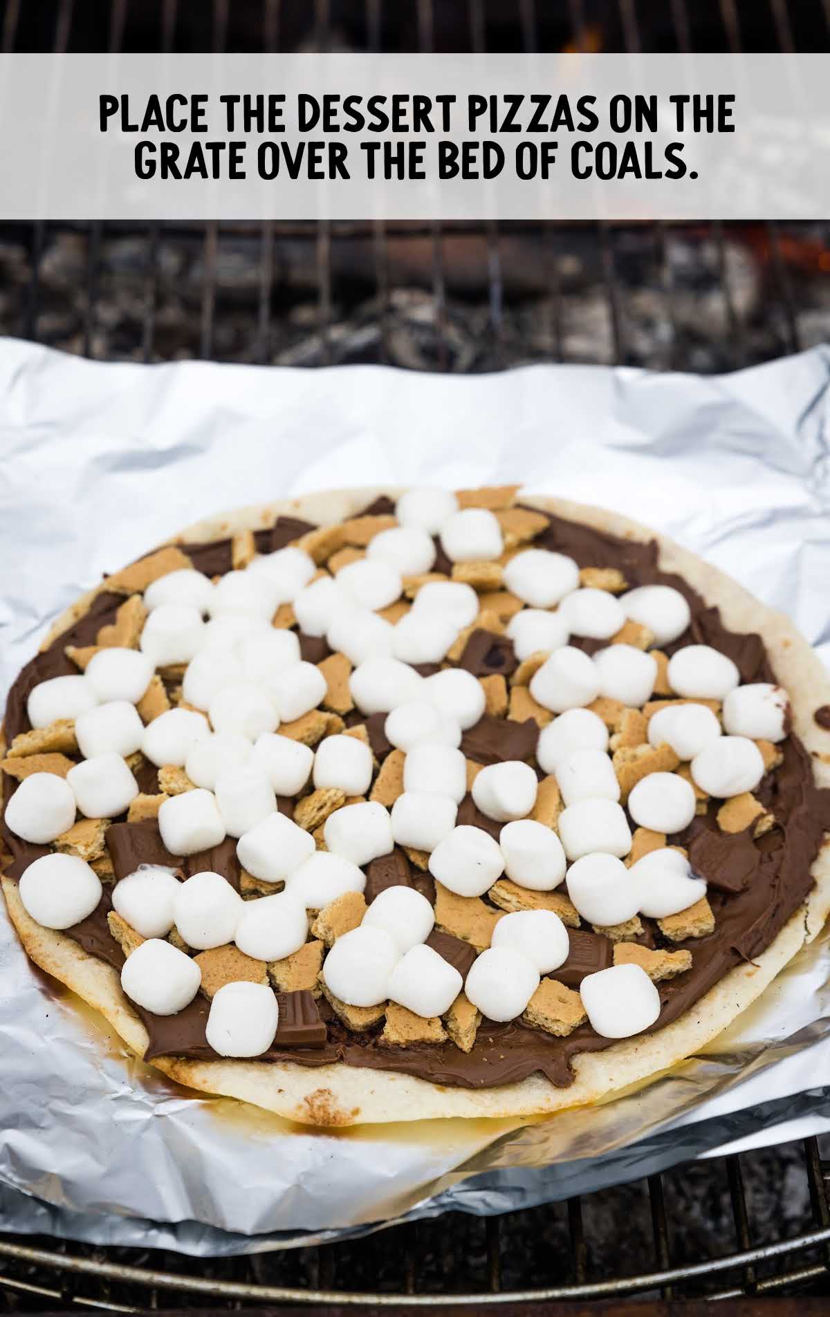 dessert pizza placed on top of aluminum foil then placed on a grill