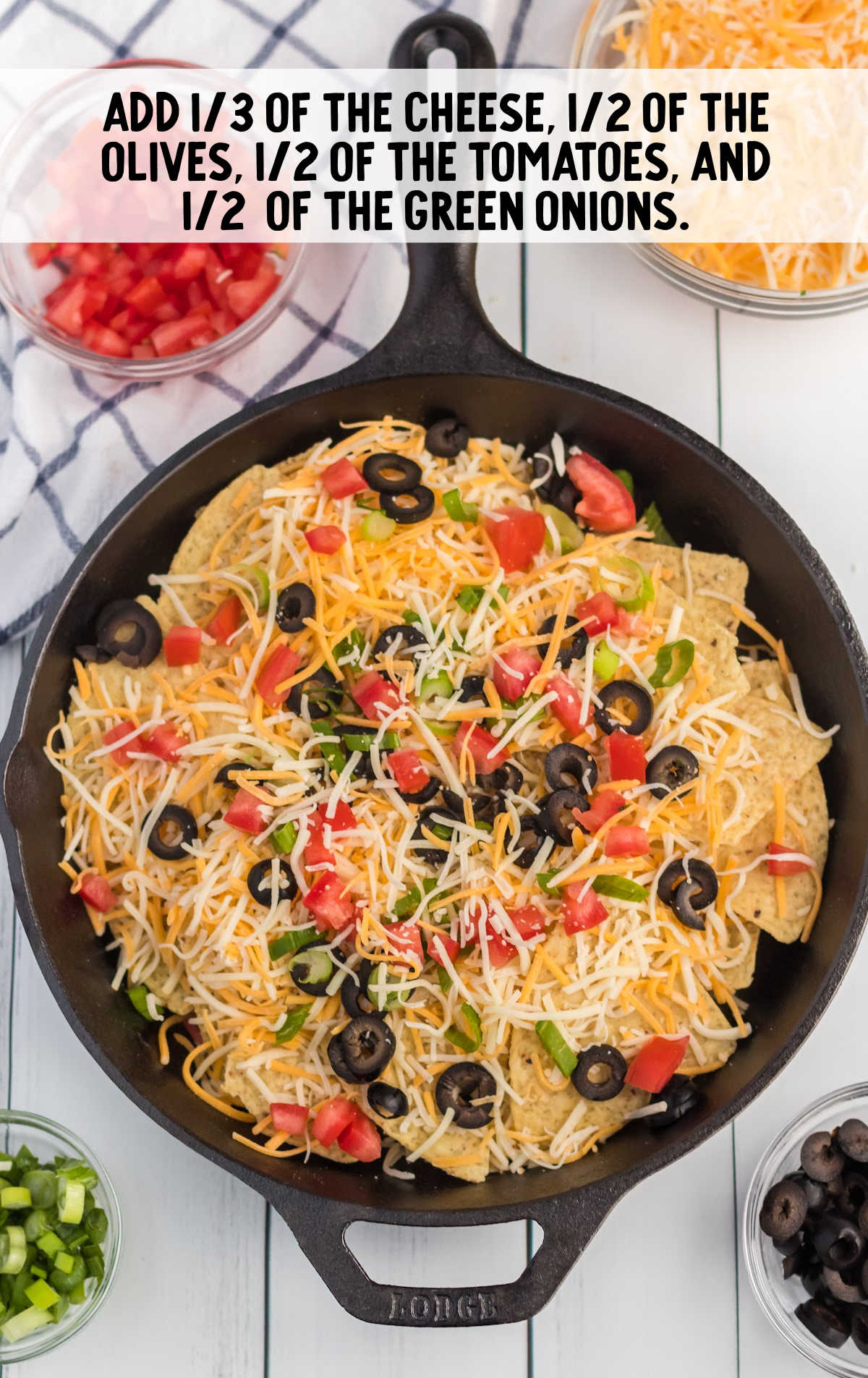 nachos topped with toppings in a skillet