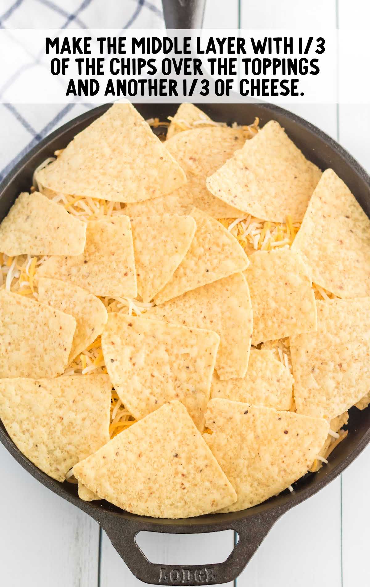 nachos topped with another layer of tortilla chips