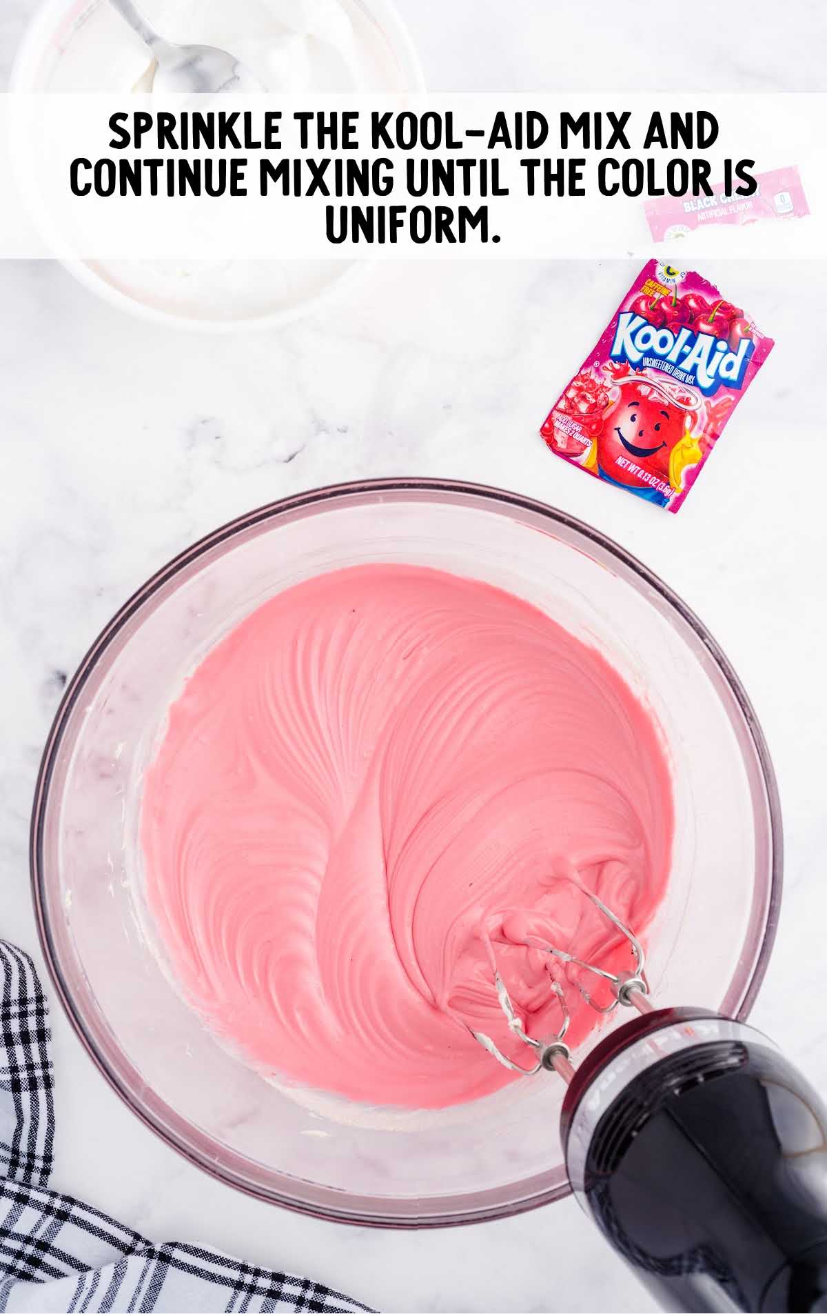 kool-aid blended into the cream cheese mixture in a bowl