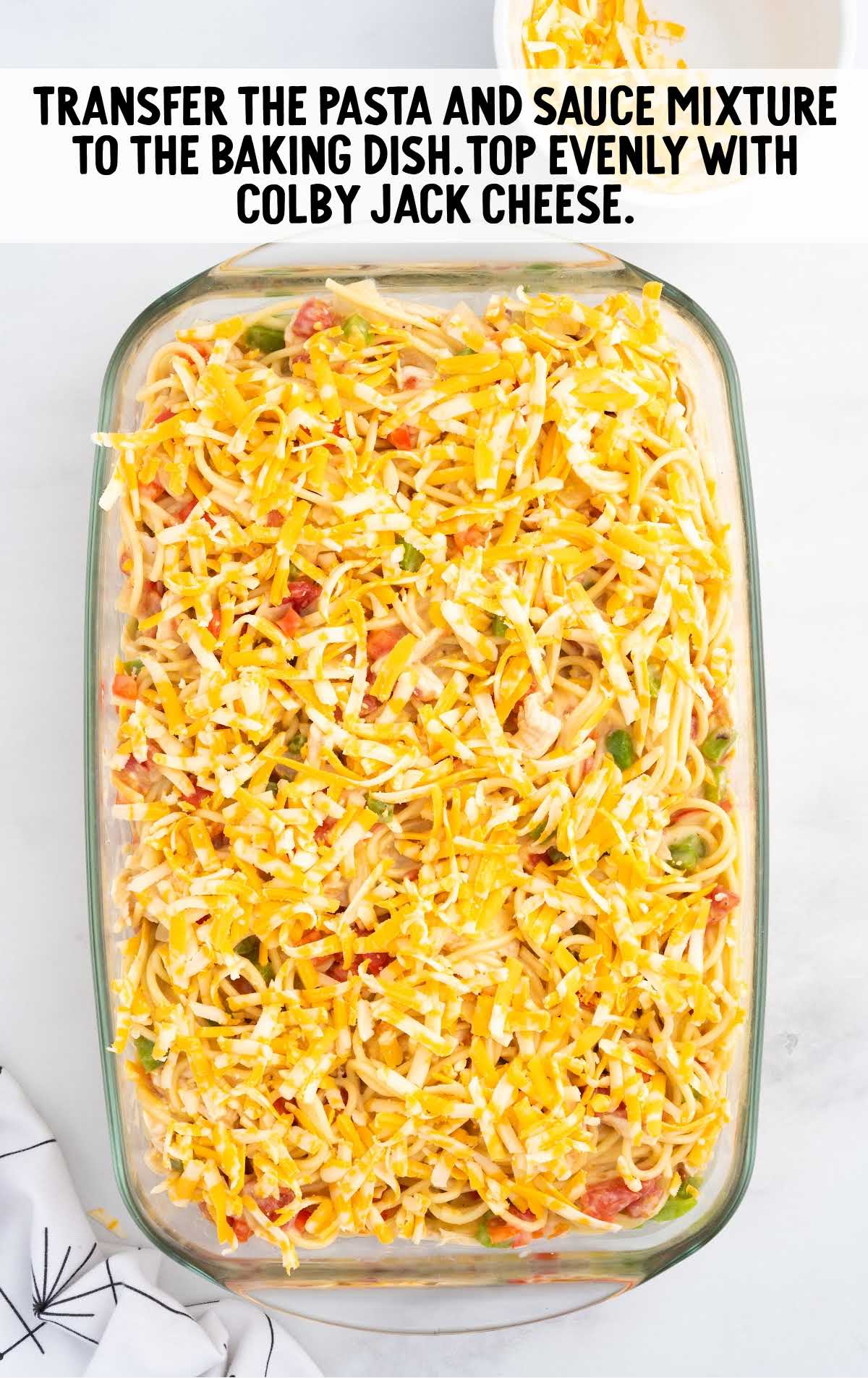 pasta mixture placed in a baking dish then topped with cheese