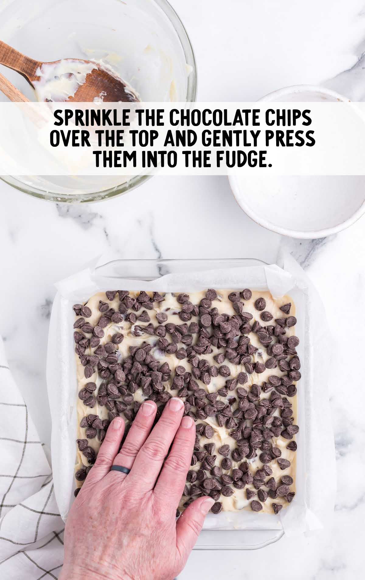 chocolate chips sprinkled over the fudge in a baking dish