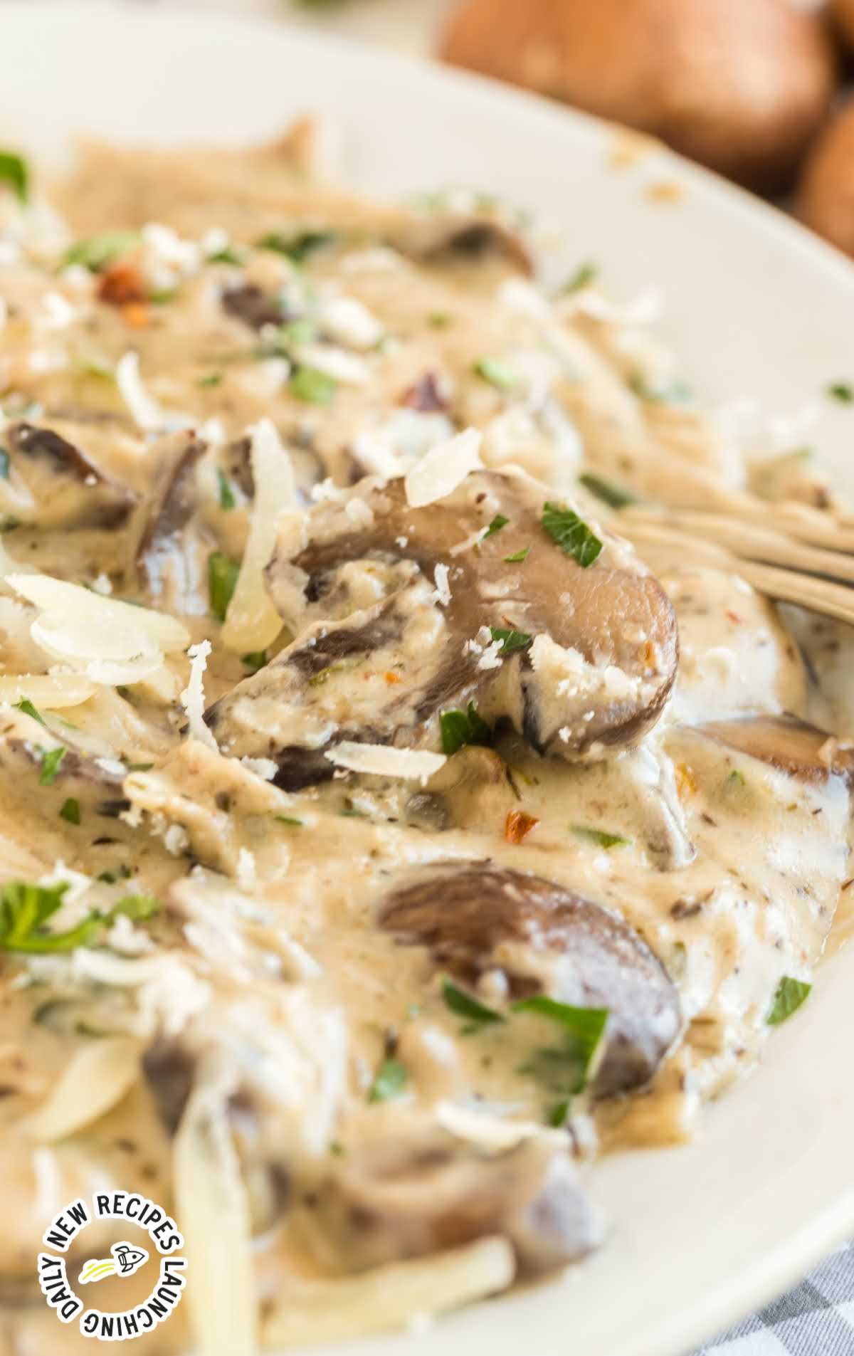 close up shot of a plate of Garlic Parmesan Mushrooms garnished with parsley