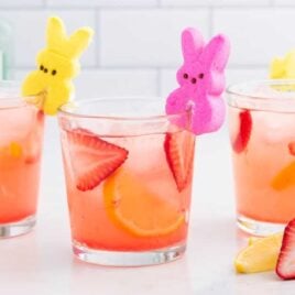 cocktails in glasses with sliced strawberries and lemons garnished with PEEPS Bunny candy