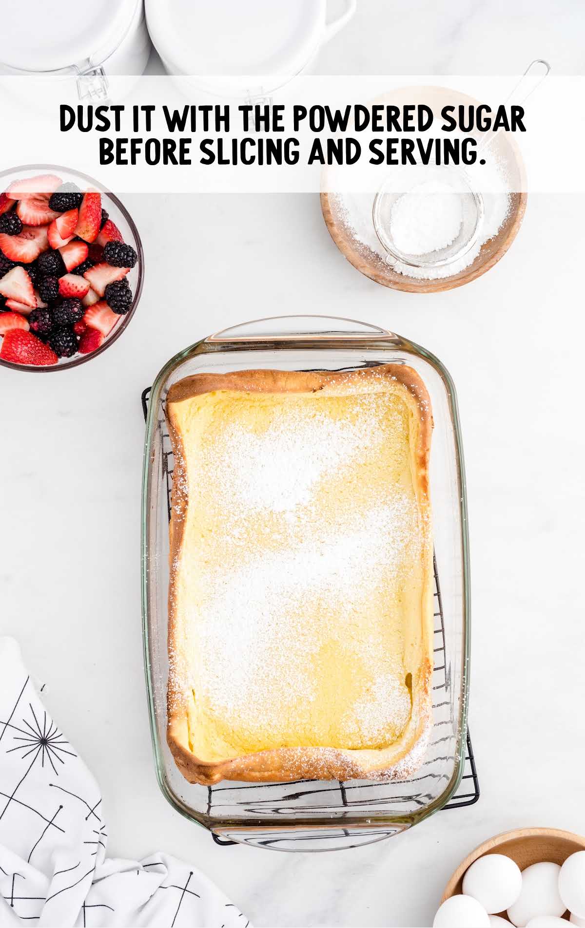 powdered sugar sprinkled on top of the Dutch Baby in a baking dish
