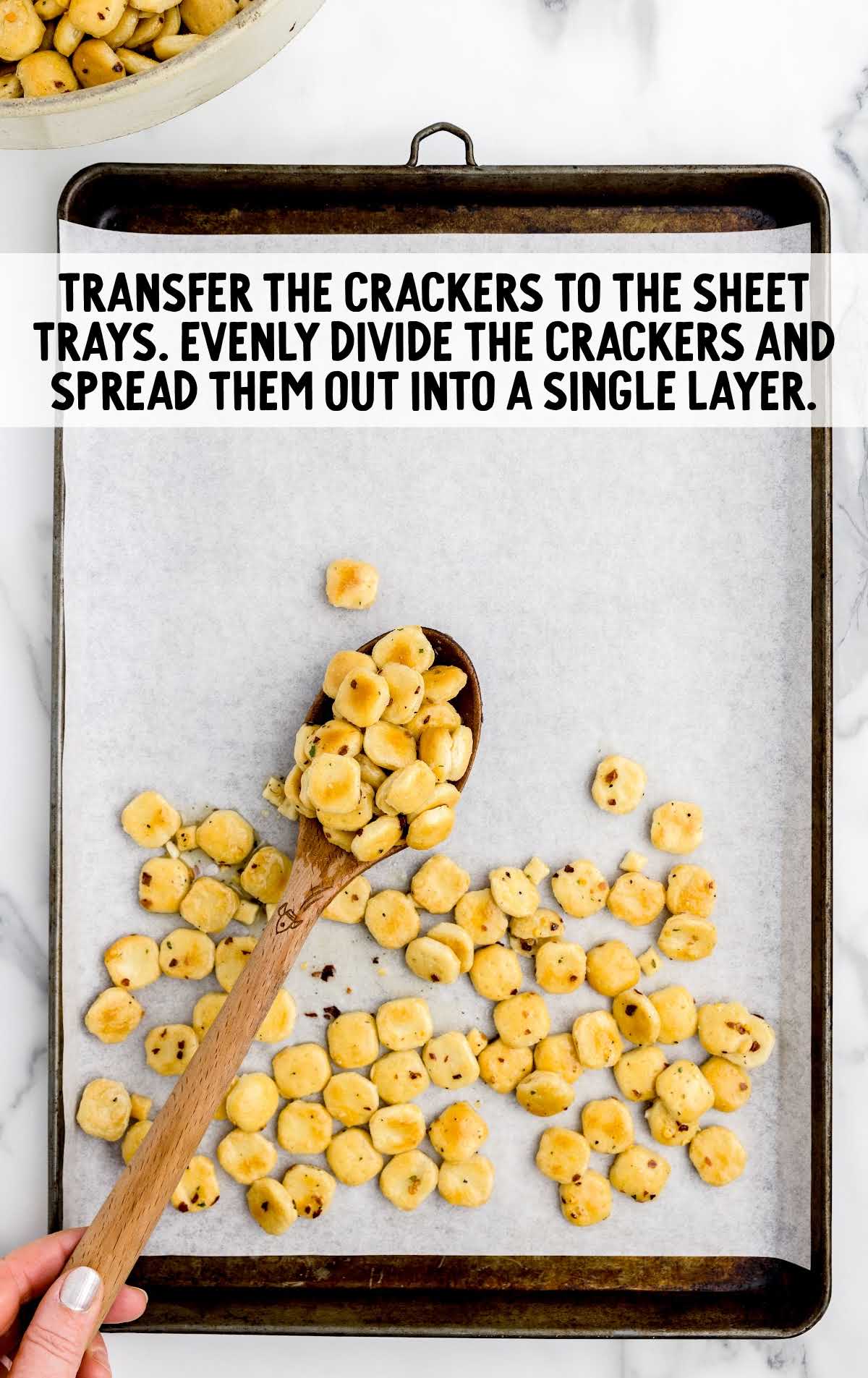 oyster crackers spread on a parchment lined baking sheet