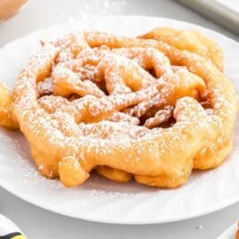 close up shot of a Funnel Cake sprinkled with powdered sugar