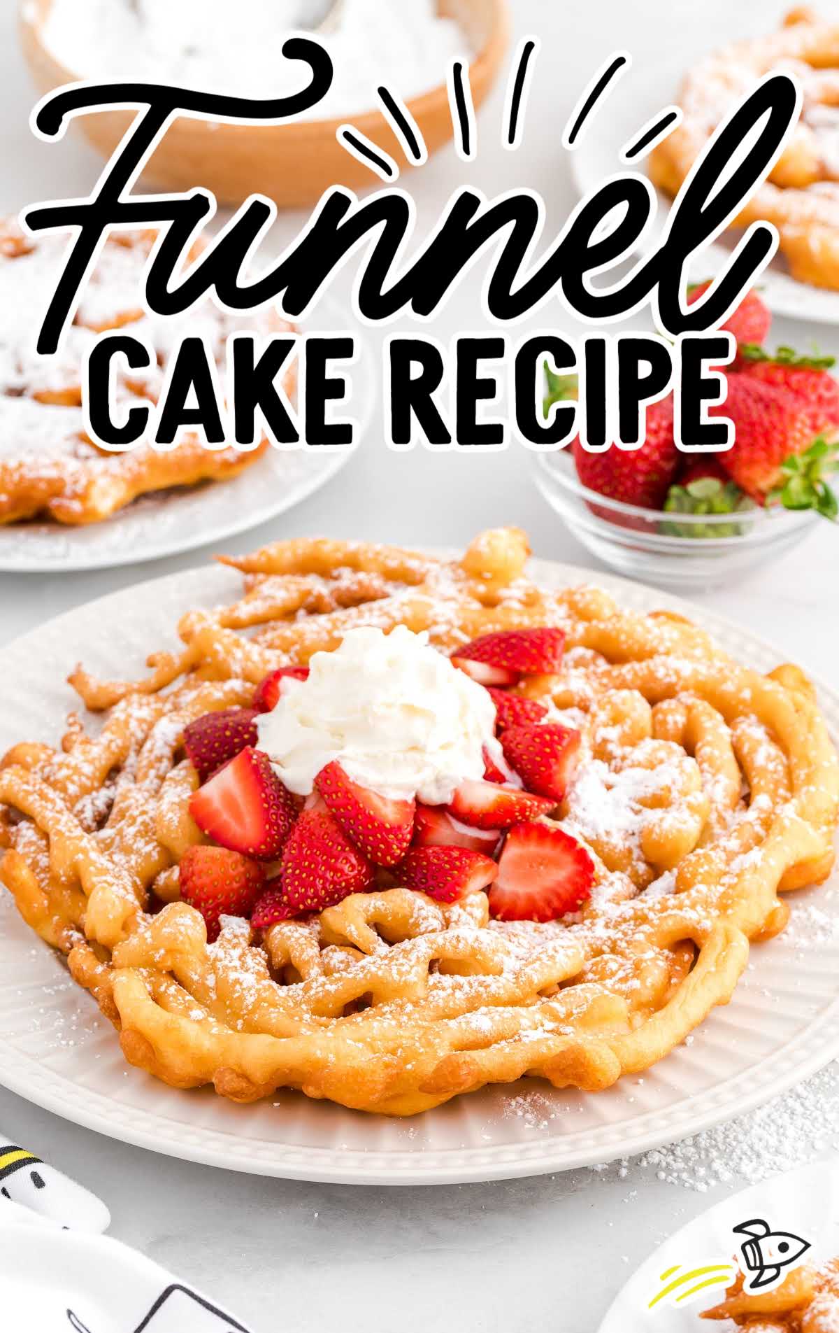 close up shot of a Funnel Cake topped with strawberries and whipped cream