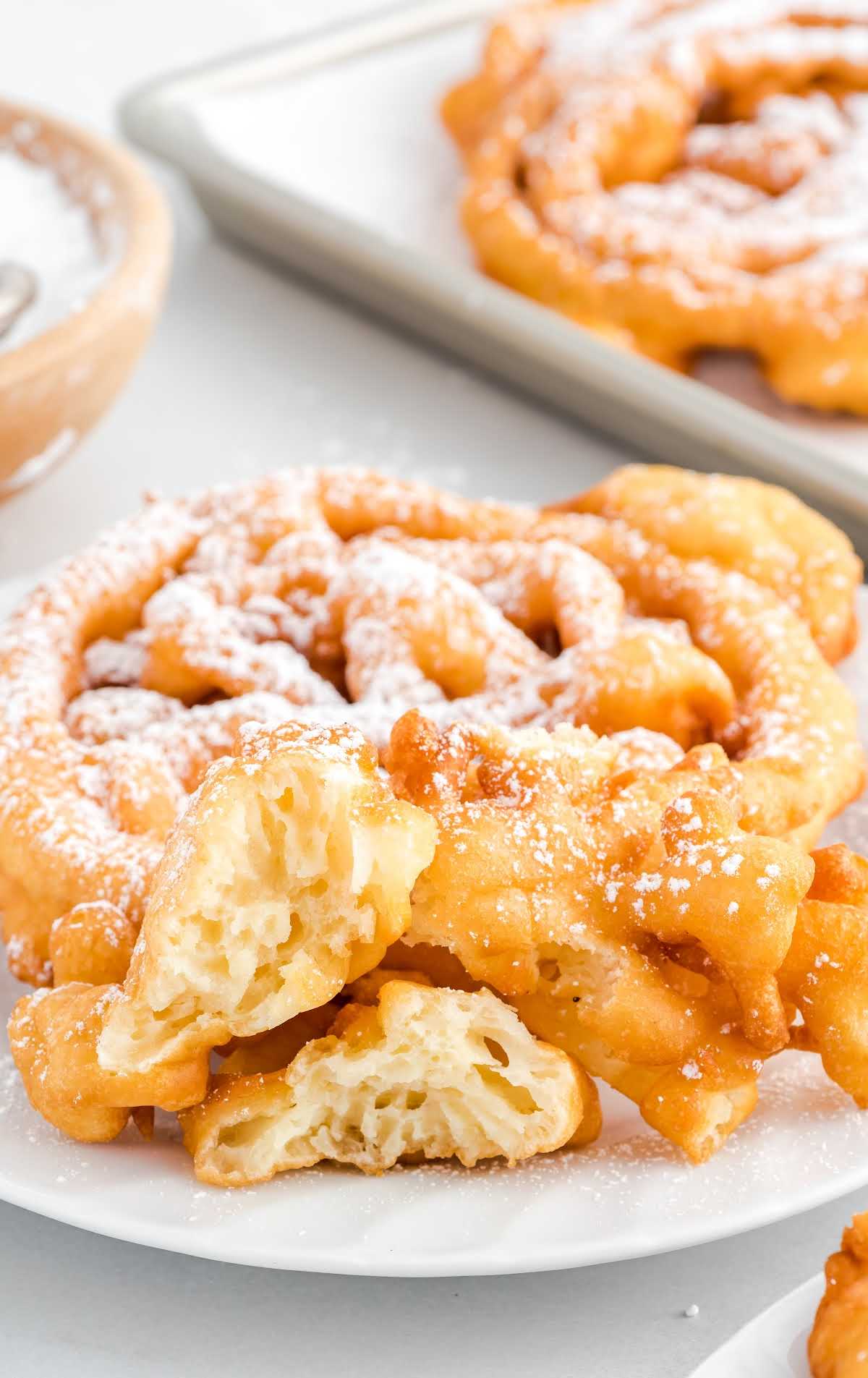 close up shot of a Funnel Cake sprinkled with powdered sugar