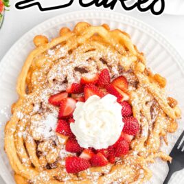 close up overhead shot of a Funnel Cake topped with strawberries and whipped cream