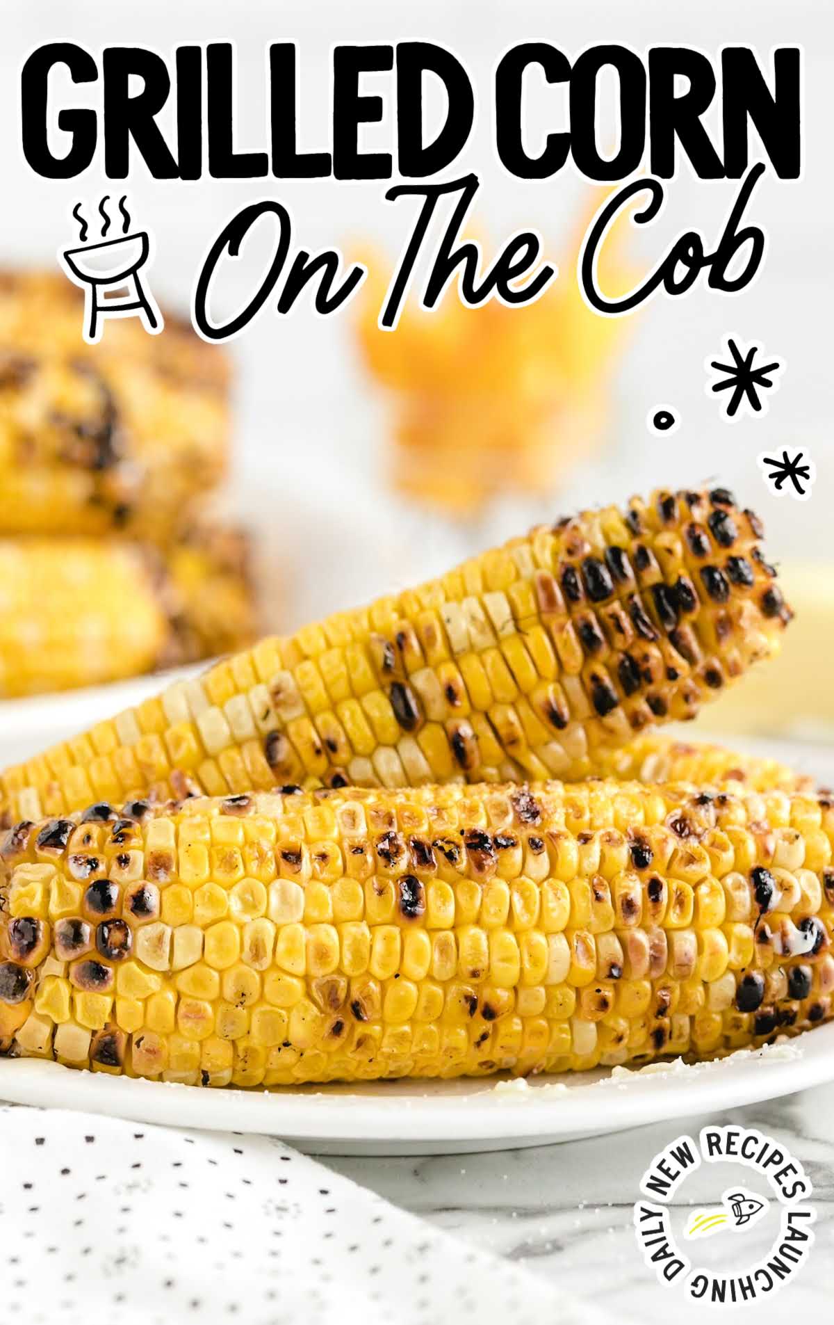 close up shot of grilled corn on the cob on a plate 