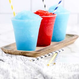 close up shot of cups of slurpees with straws
